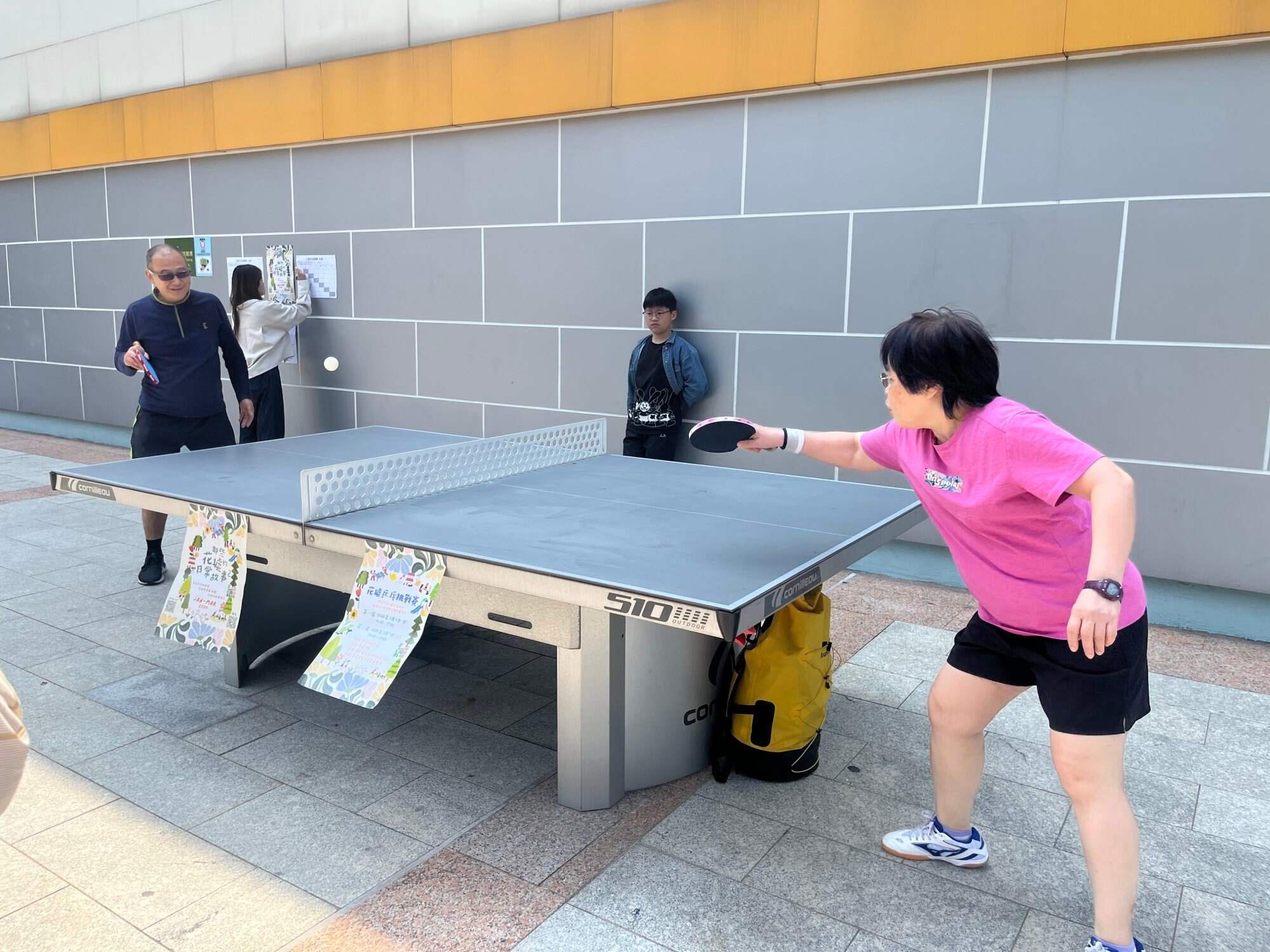 People gather to play table tennis outside Boundary Street Sports Centre in Prince Edward. Photo: Kelly Fung