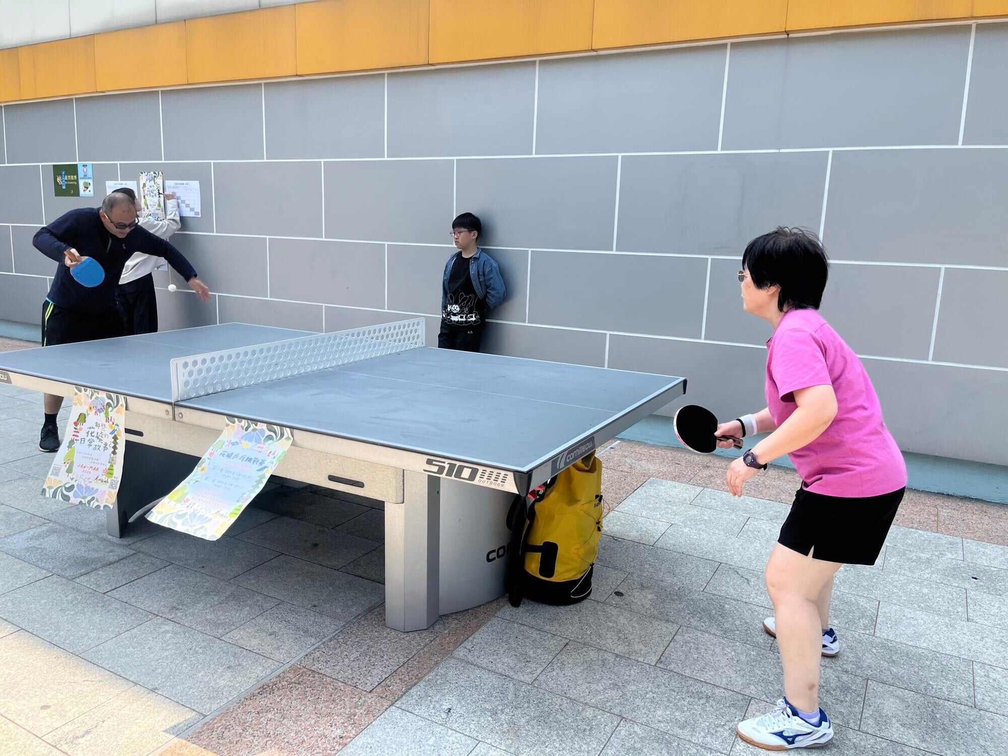 People gather outside Boundary Street Sports Centre to play table tennis. Photo: Kelly Fung