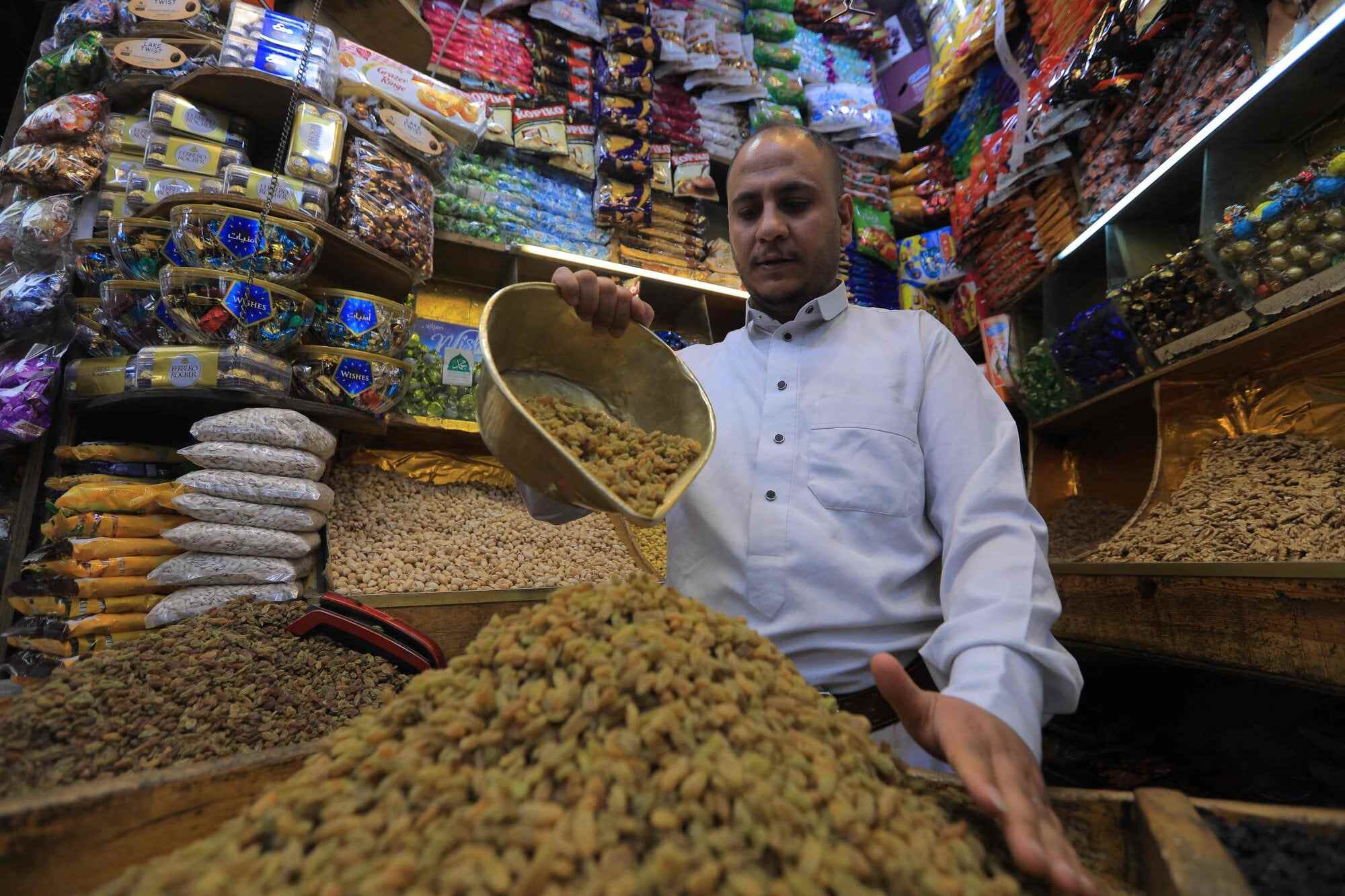 In Sanaa, the capital of Yemen, a man sorts dried fruits and nuts in a market. Photo: AFP