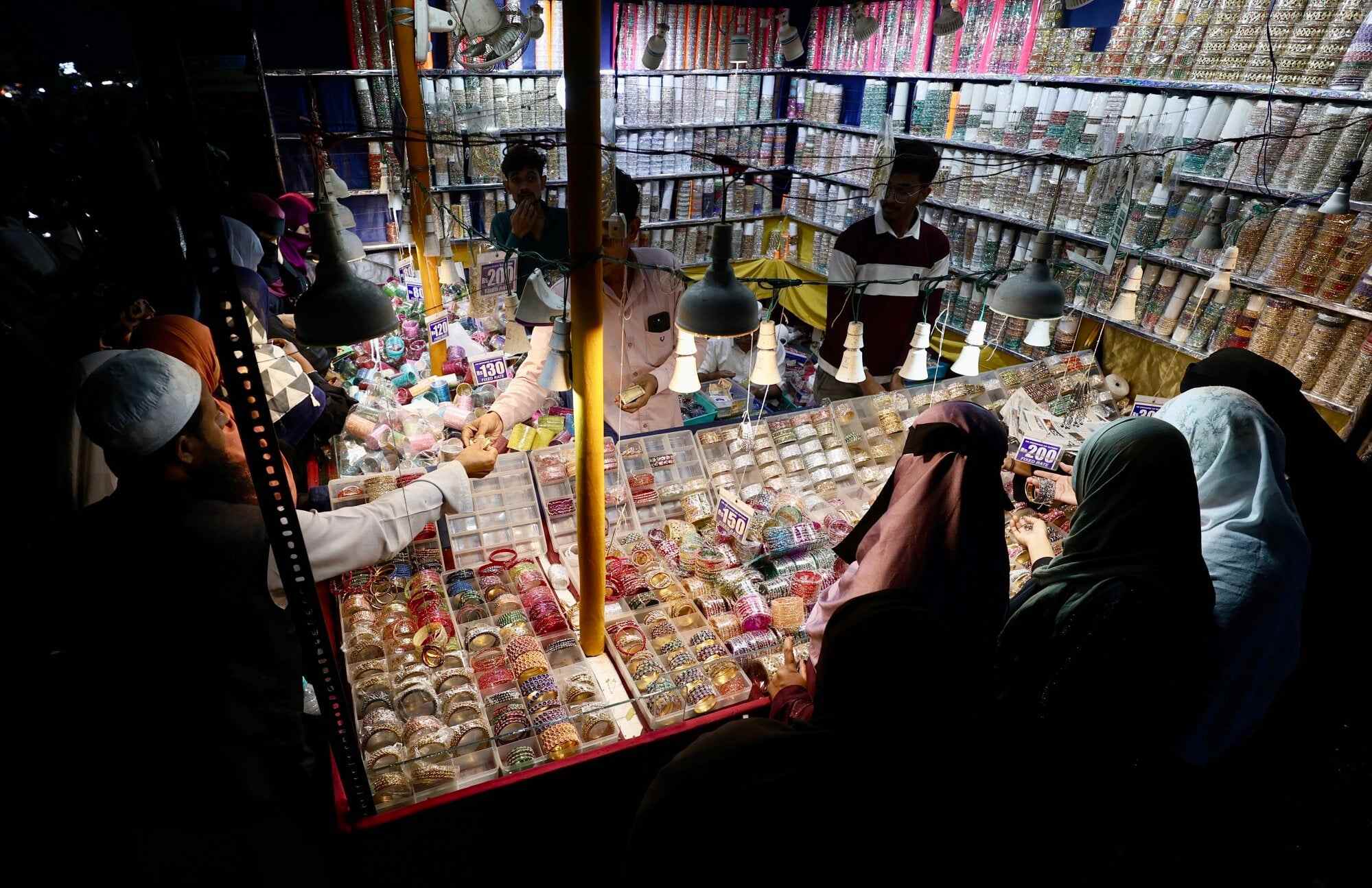 People shop for jewellery at a street market in Bengaluru, India. Photo: EPA