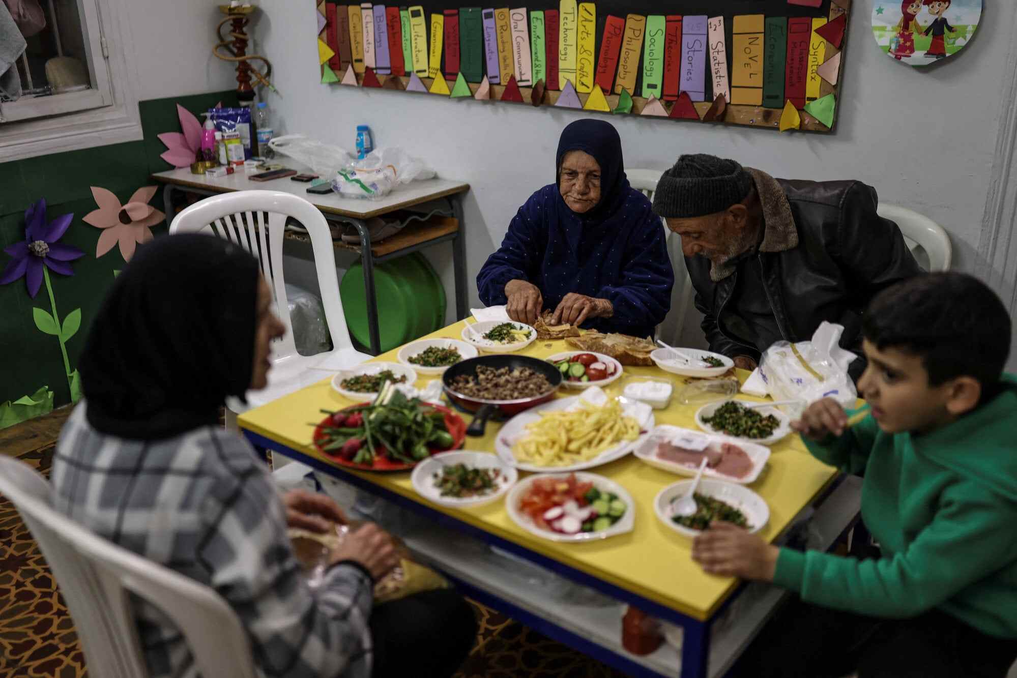 Displaced people break their fast at iftar, the evening meal held after sunset, inside a school in Beirut, Lebanon. The school has been converted into a shelter following an escalation between the militant group Hezbollah and Israel amid the US-Israeli conflict with Iran. Photo: Reuters