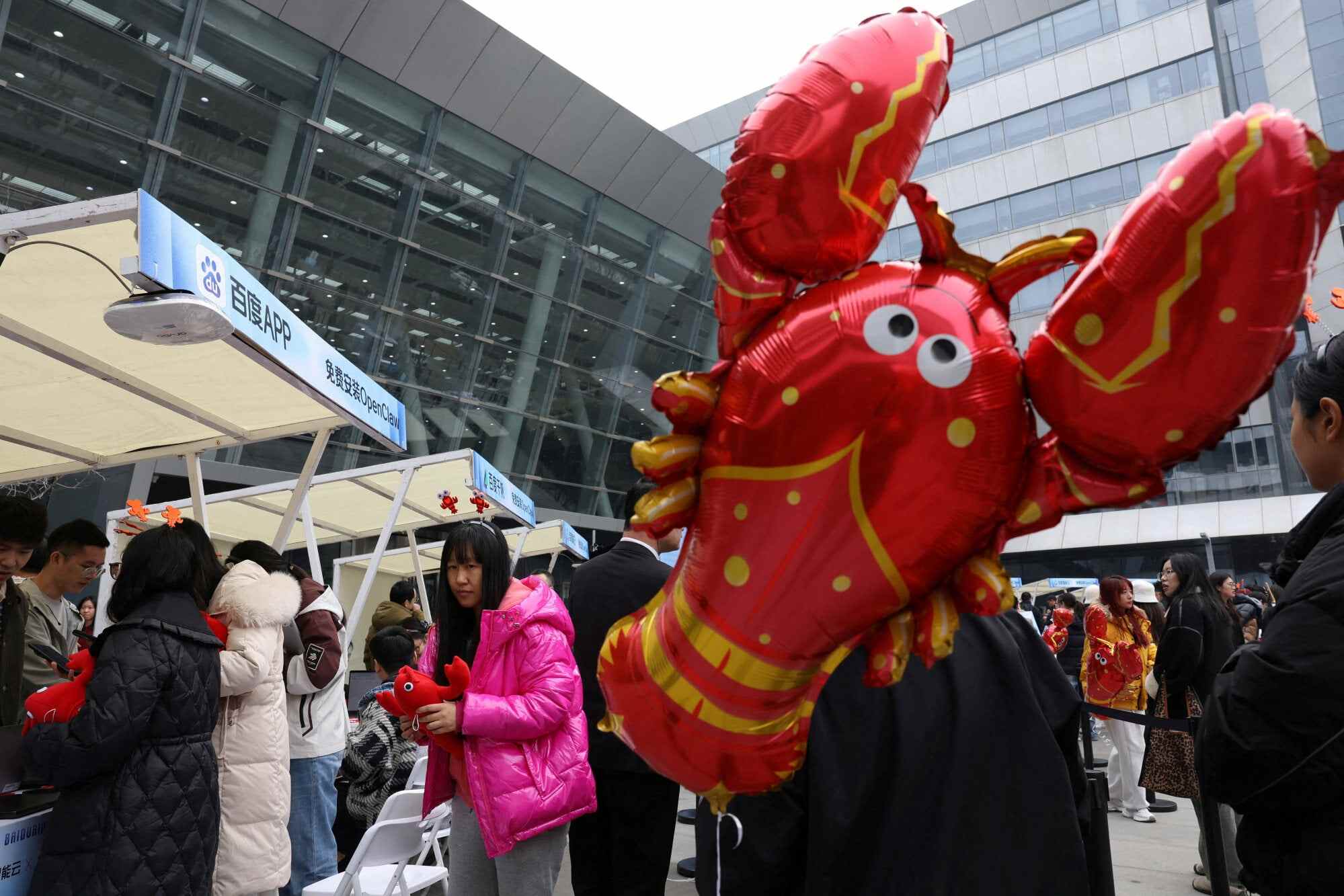 Participants queue near a lobster-shaped balloon to set up and install OpenClaw, an open-source AI agent, outside the Baidu offices in Beijing, China. Photo: Reuters