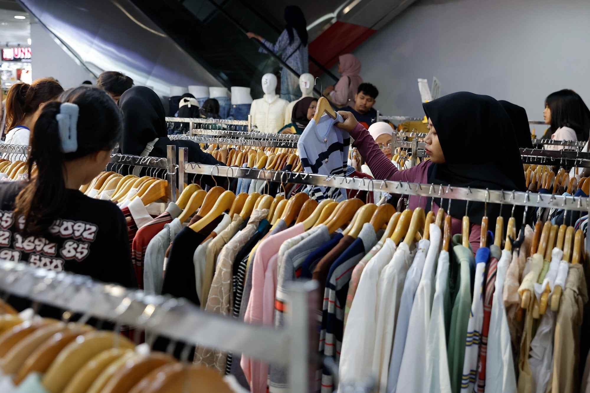 People shop for clothes ahead of Eid Al Fitr celebrations at the Tanah Abang market in Jakarta, Indonesia. Photo: EPA