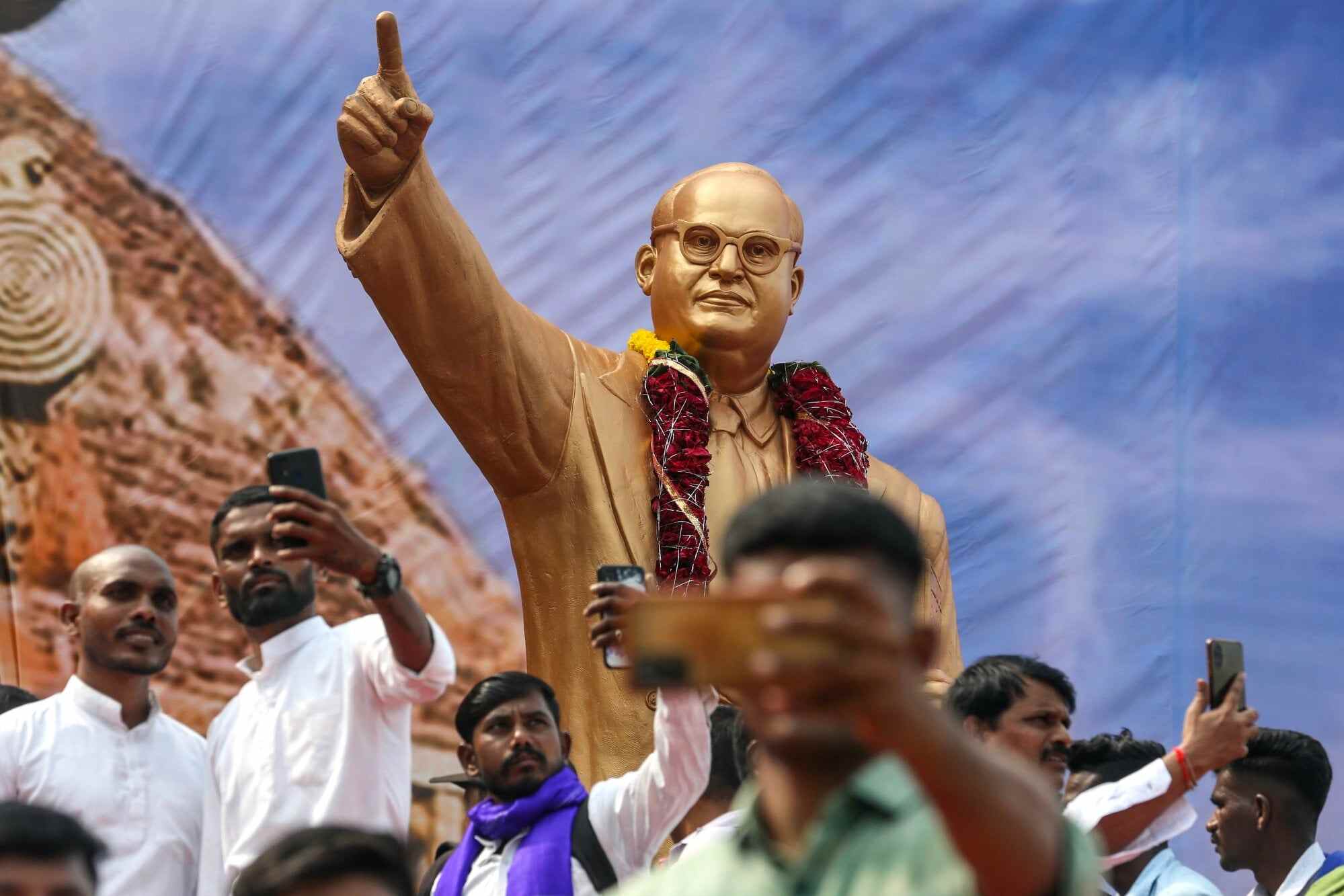 Indian Dalits, formerly known as ‘untouchables’, and supporters of Bhimrao Ambedkar, who inspired the Dalit Buddhist movement, take selfies near his statue at Shivaji Park on the 67th anniversary of his death, in Mumbai, India. Photo: EPA-EFE