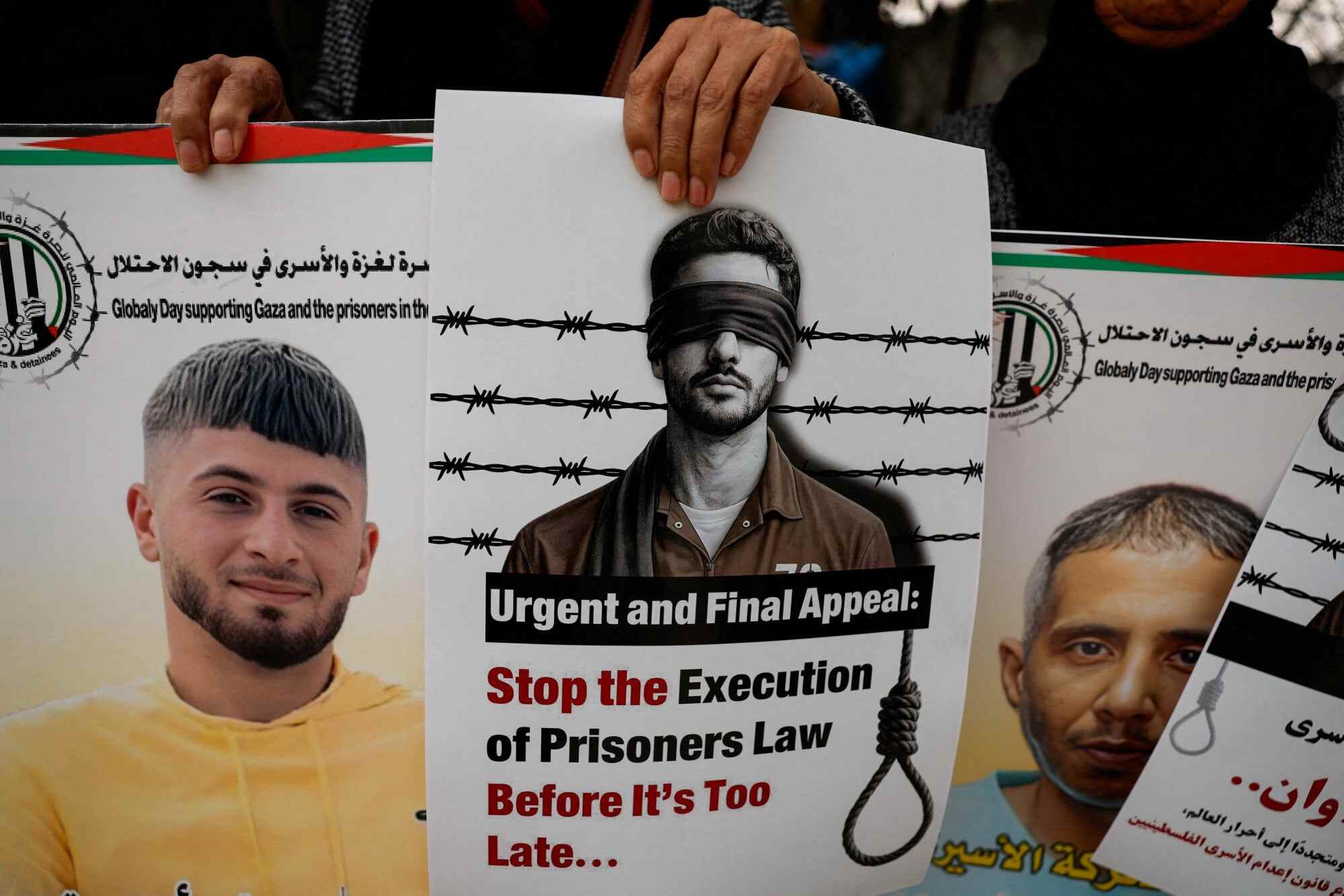 Palestinians hold placards as they take part in a protest in Ramallah in the Israeli-occupied West Bank. Photo: Reuters