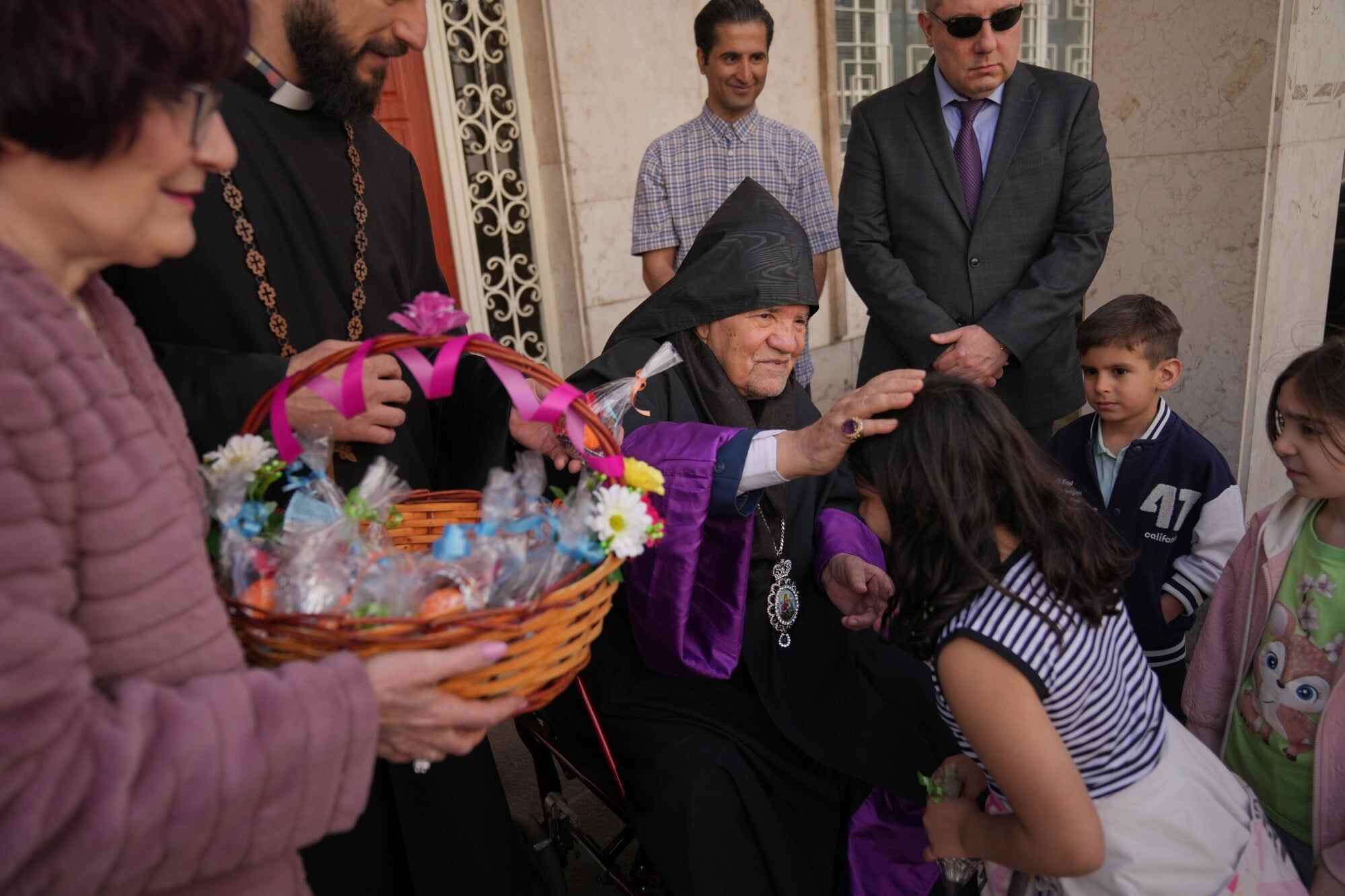 Sepuh Sargsyan, archbishop and prelate of the Armenian Apostolic Diocese of Tehran, blesses a child after Easter Sunday Mass at Saint Sarkis Cathedral in Tehran, Iran. Photo: AP
