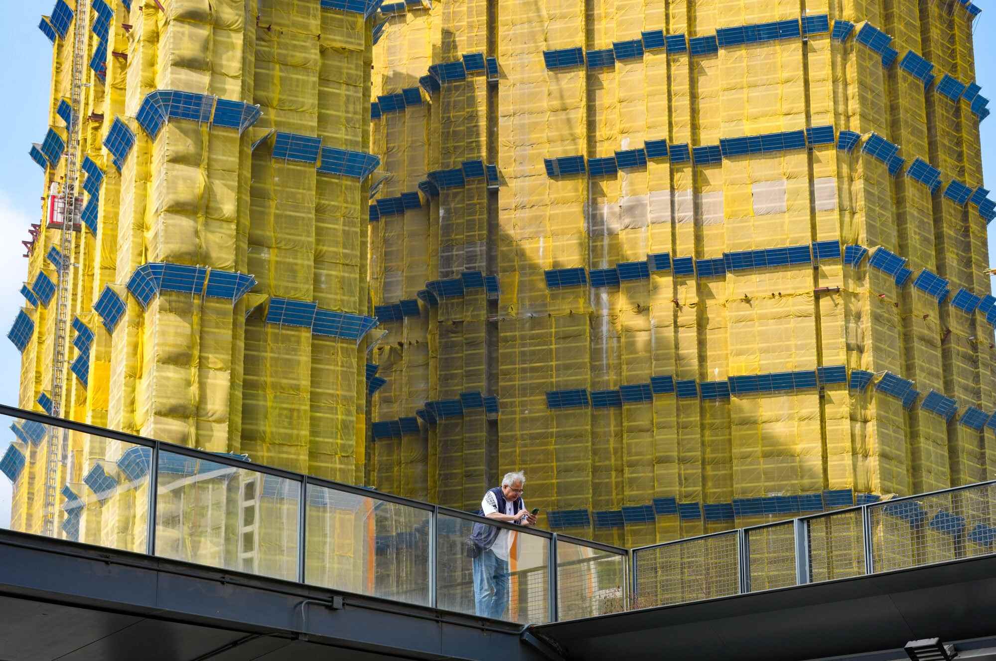 A man looks at his mobile phone in front of a privately owned construction site in Kai Tak. Hong Kong is consistently ranked among the world’s least attainable property markets. Photo: Jelly Tse