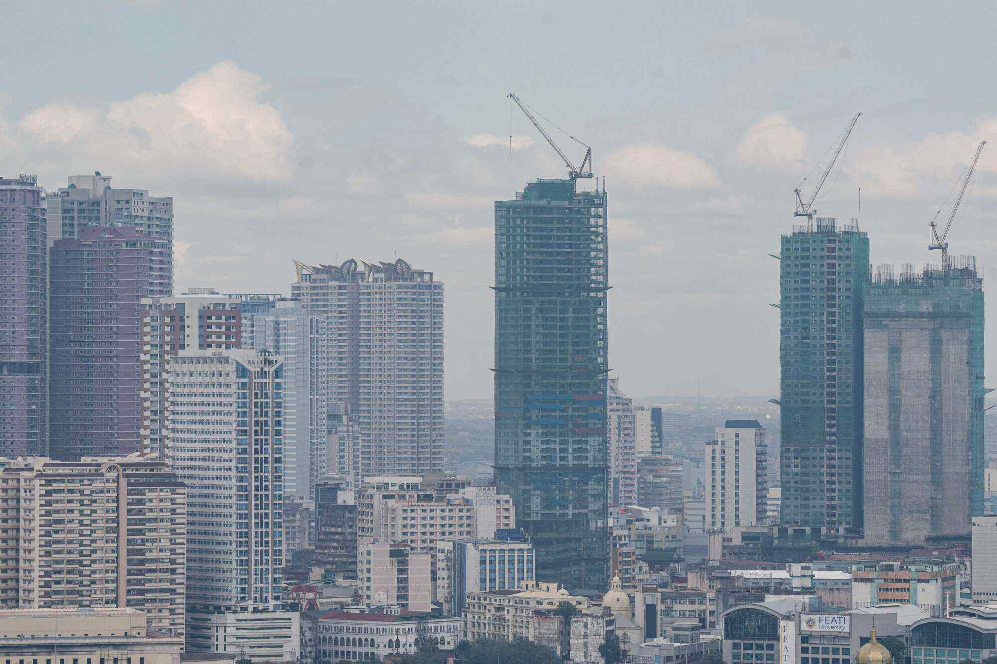 A general view of cranes atop buildings under construction in Manila. In Manila or Yangon, far more people simply cannot cover the basic costs of living. Photo: AFP