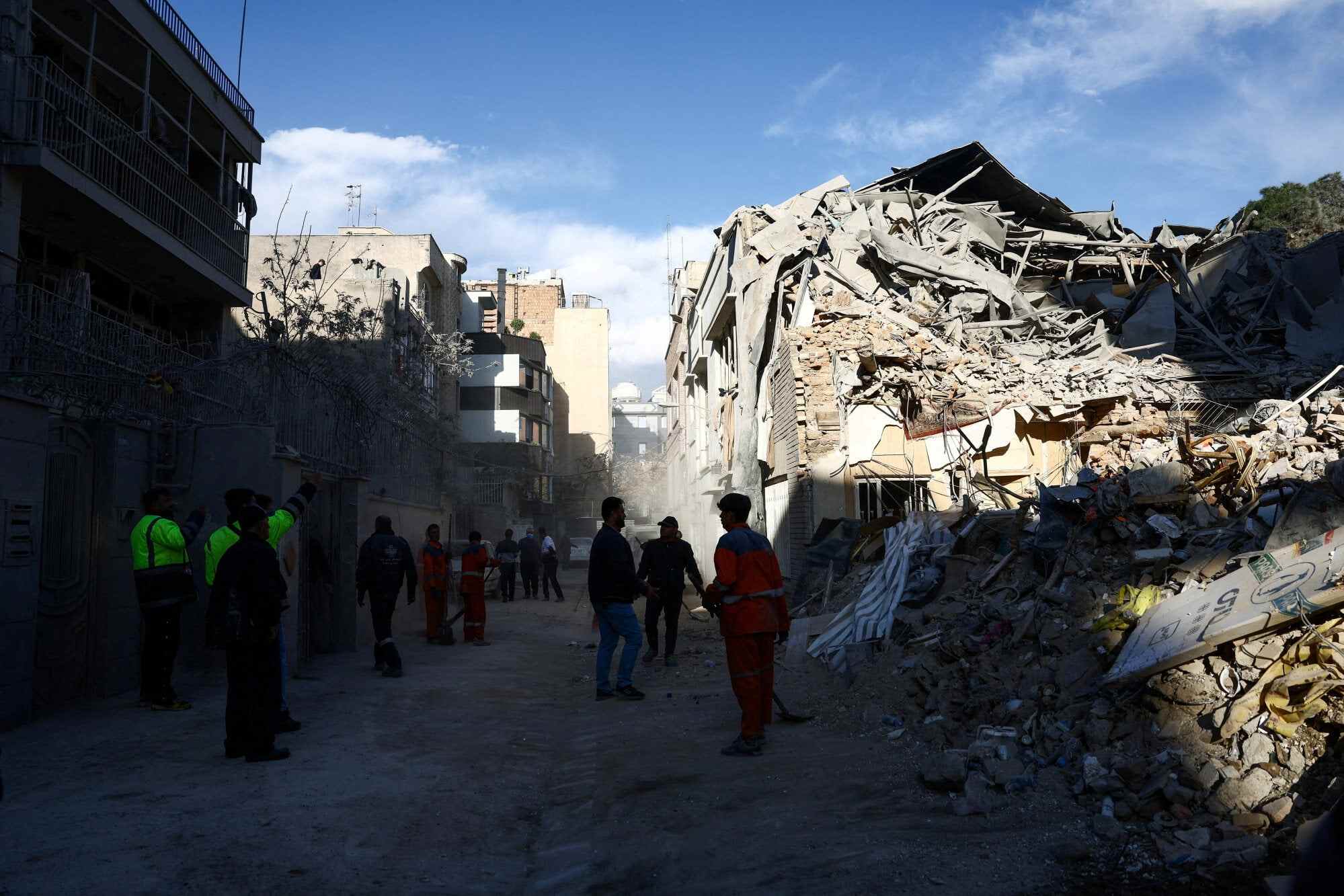 People stand next to a synagogue in Tehran that was damaged in a strike during the US-Israeli war on Iran. Photo: Reuters
