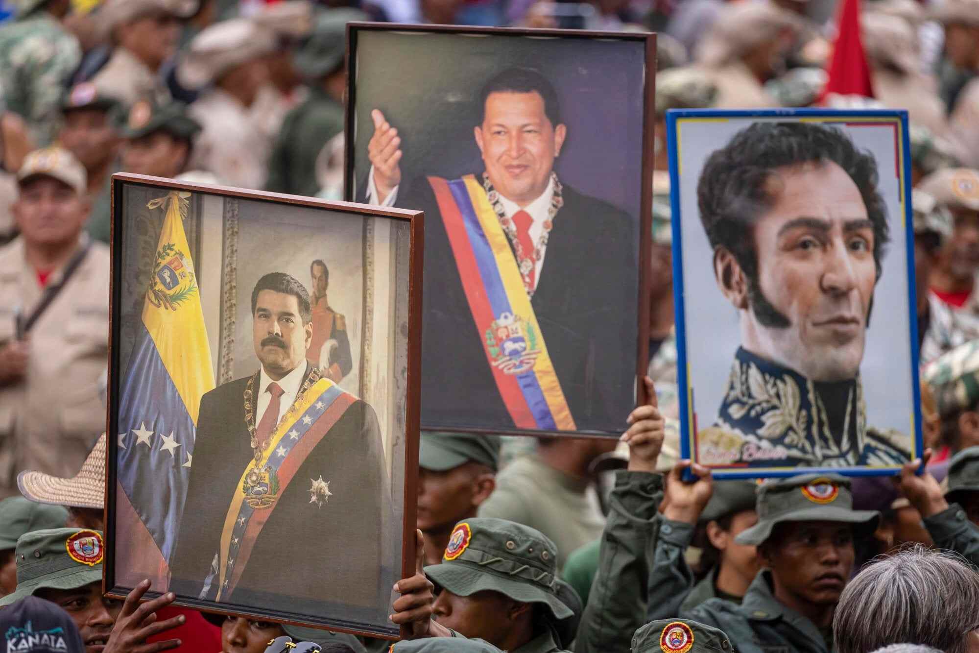 Images of Venezuela’s deposed president Nicolas Maduro, the late Venezuelan president Hugo Chavez and Simon Bolivar during a march to commemorate National Dignity Day, a date marking the return of Chavez to the presidency after being ousted in a coup, in Caracas, Venezuela. Photo: EPA