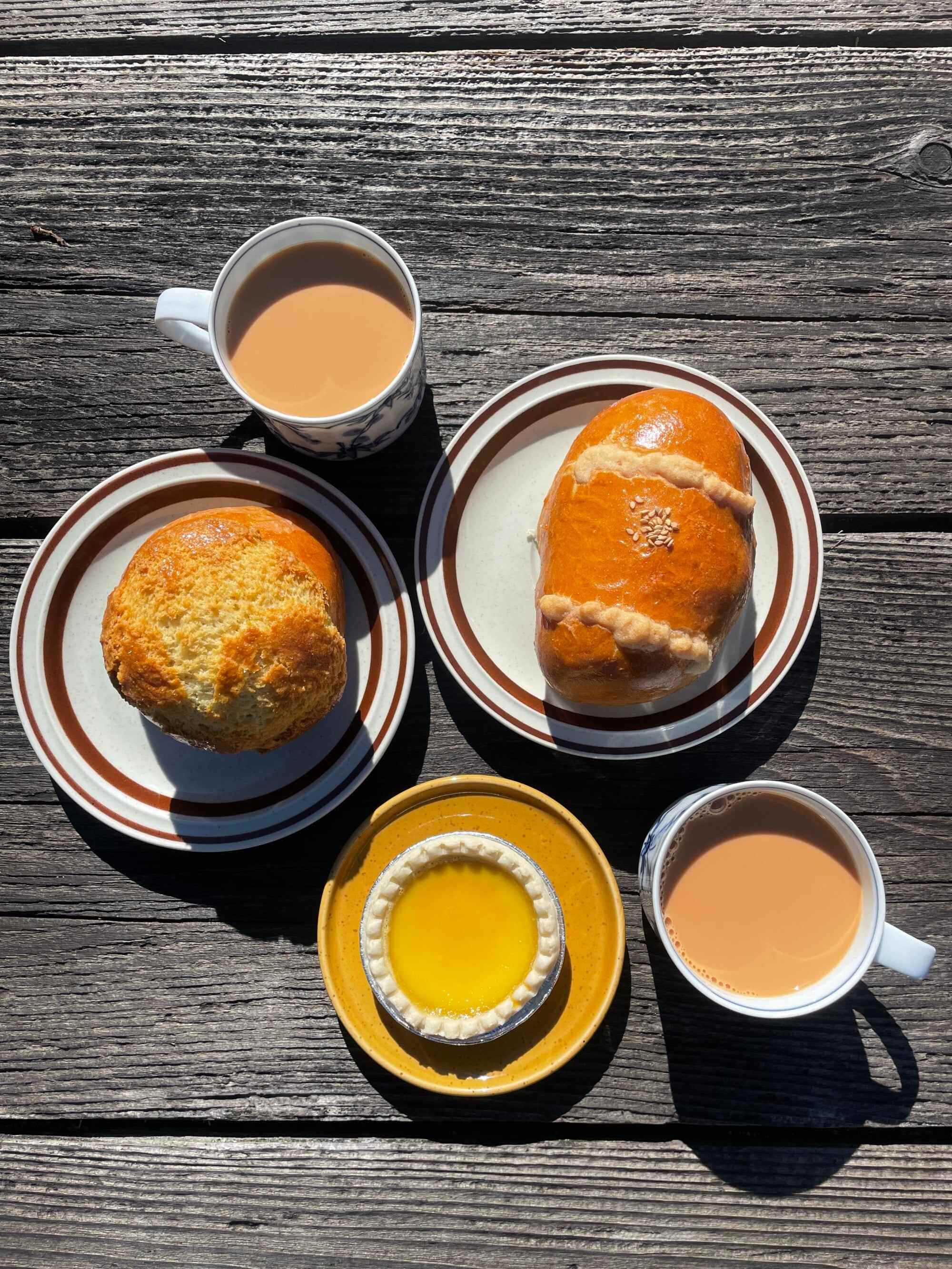 A pineapple bun, a cocktail bun, egg tarts and Hong Kong-style milk tea at Unique Slow Rise Bakery. Photo: Unique Slow Rise Bakery
