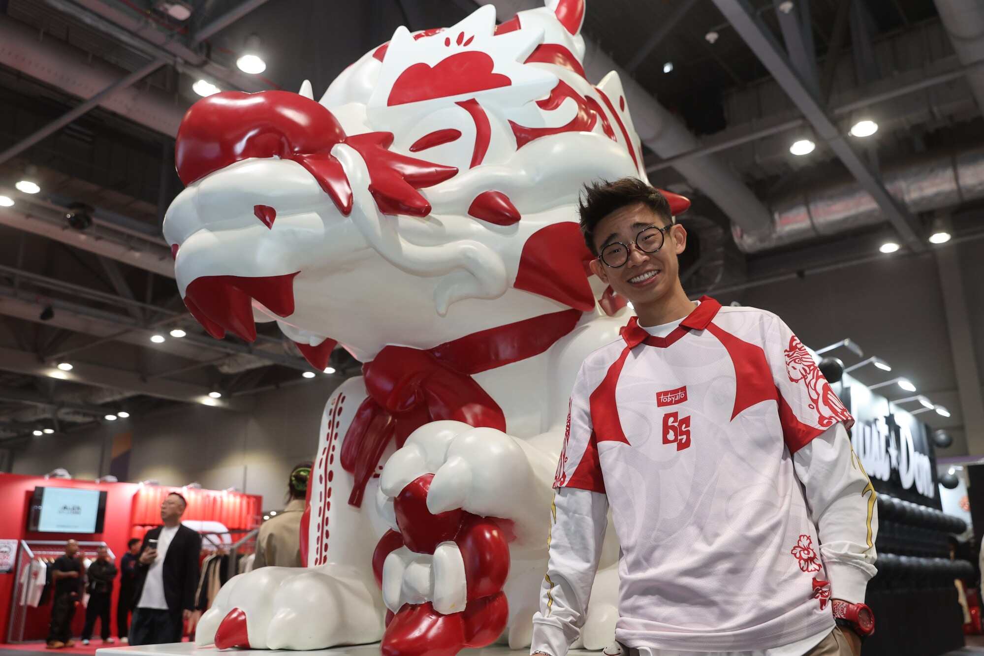 Toby Tan poses with his artwork “Sneaker Stone Dragon” at ComplexCon Hong Kong. Photo: Edmond So