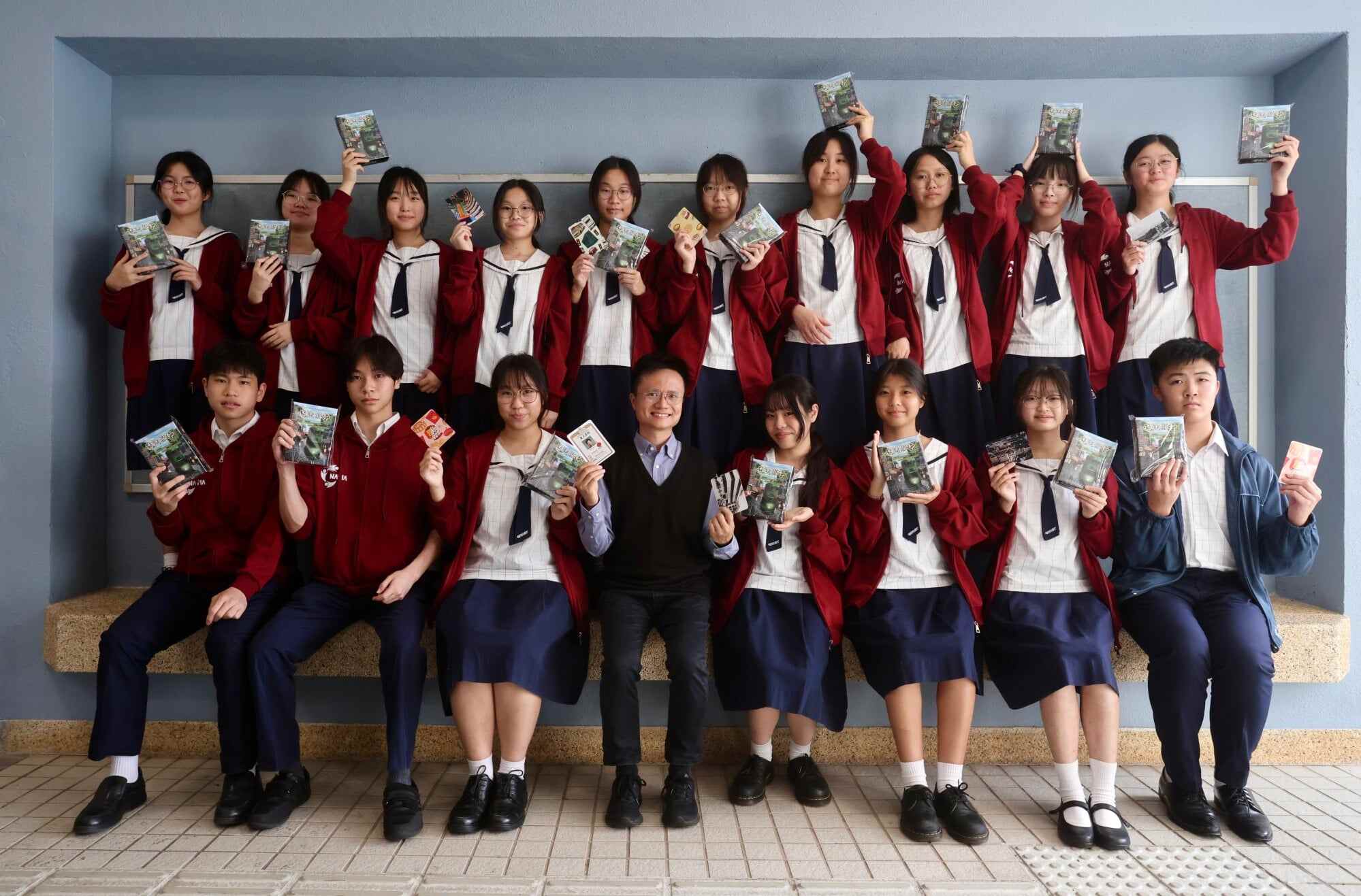 Chang Yu-hsiang (front row, centre), the faculty head of business at United Christian College (Kowloon East), poses with the team who created the Lost and Found board game. Photo: Jonathan Wong