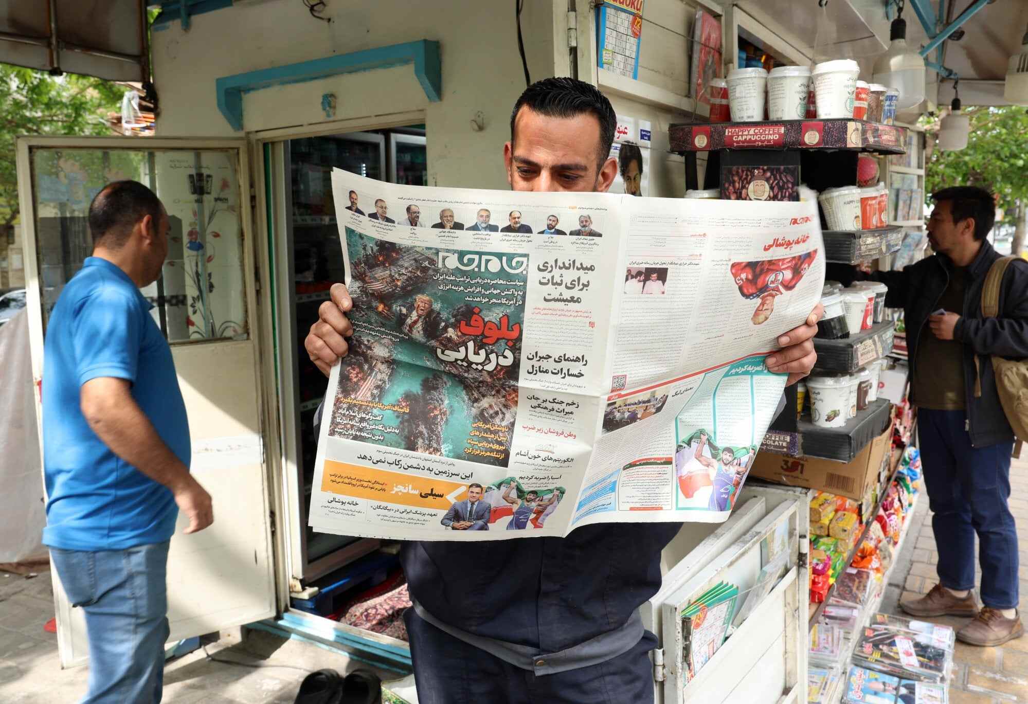 An Iranian man reads a copy of the Iranian daily newspaper Jam Jam. Photo: EPA