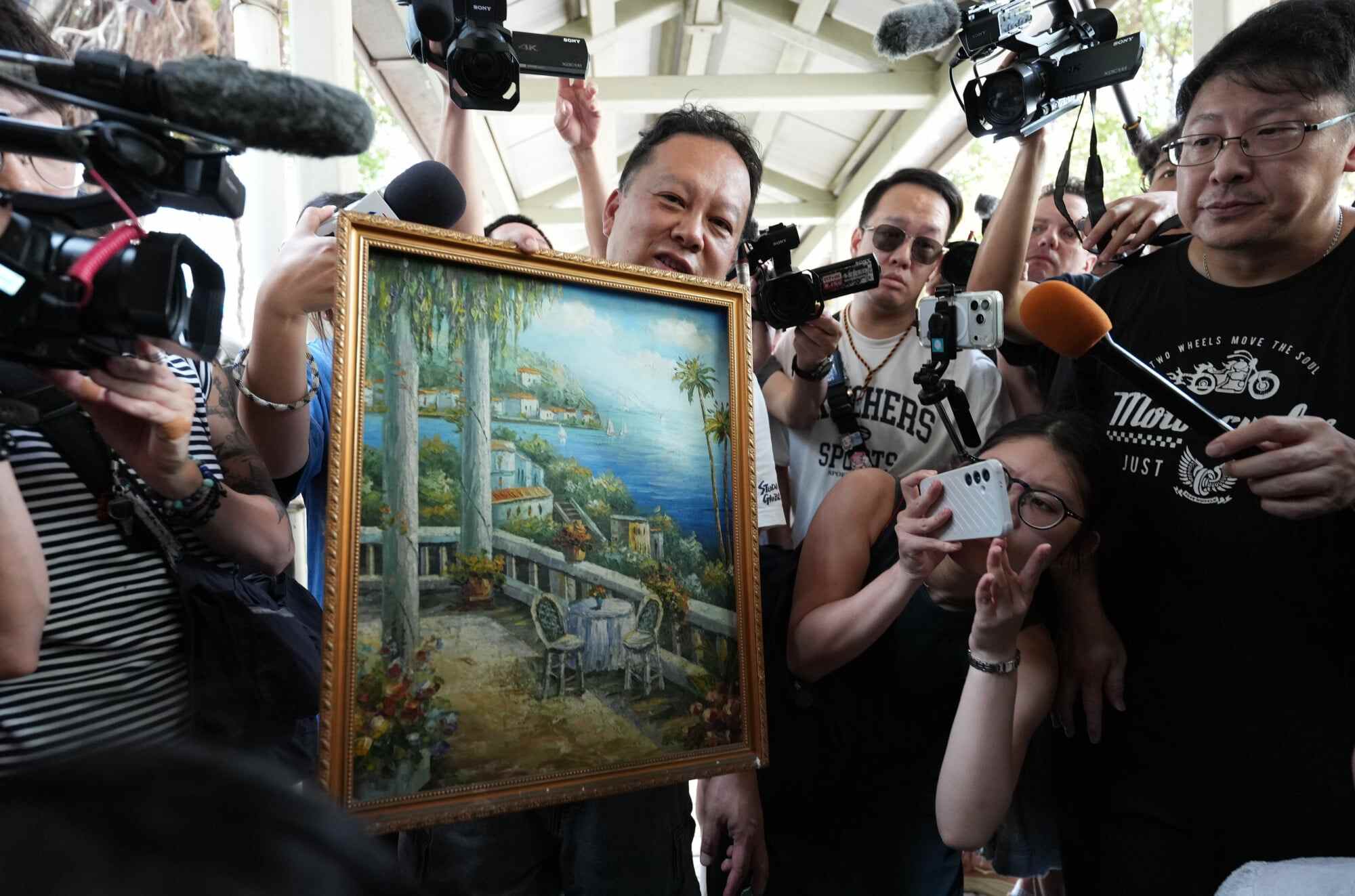 Steven Chung, a returnee to Wang Fuk Court in Tai Po, holds up a belonging he salvaged from his former home. Photo: Jelly Tse