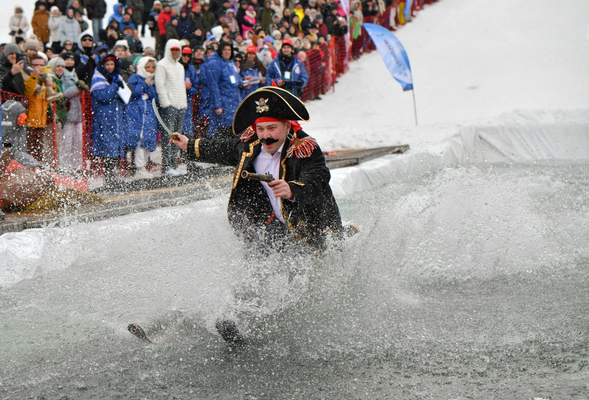 A skier attempts to cross a pool of water at the foot of a slope in Krasnoyarsk, Russia. Photo: Reuters