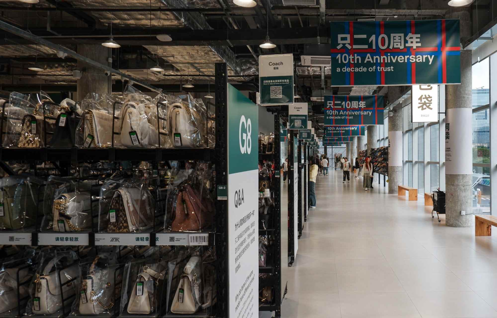 Second-hand luxury handbags at ZZER’s brick-and-mortar store in Shenzhen, China, are organised by brand, with each bag displayed in a transparent case. Photo: Alice Li