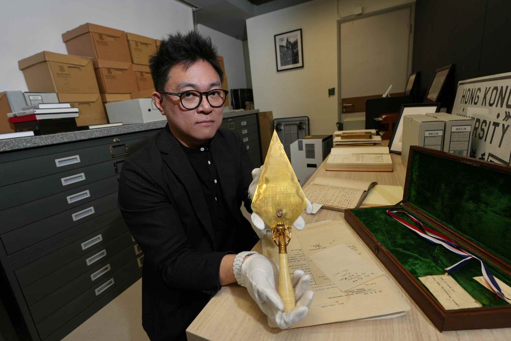 Garfield Lam holds the ceremonial trowel used for HKU’s oldest building in 1910. Photo: Karma Lo