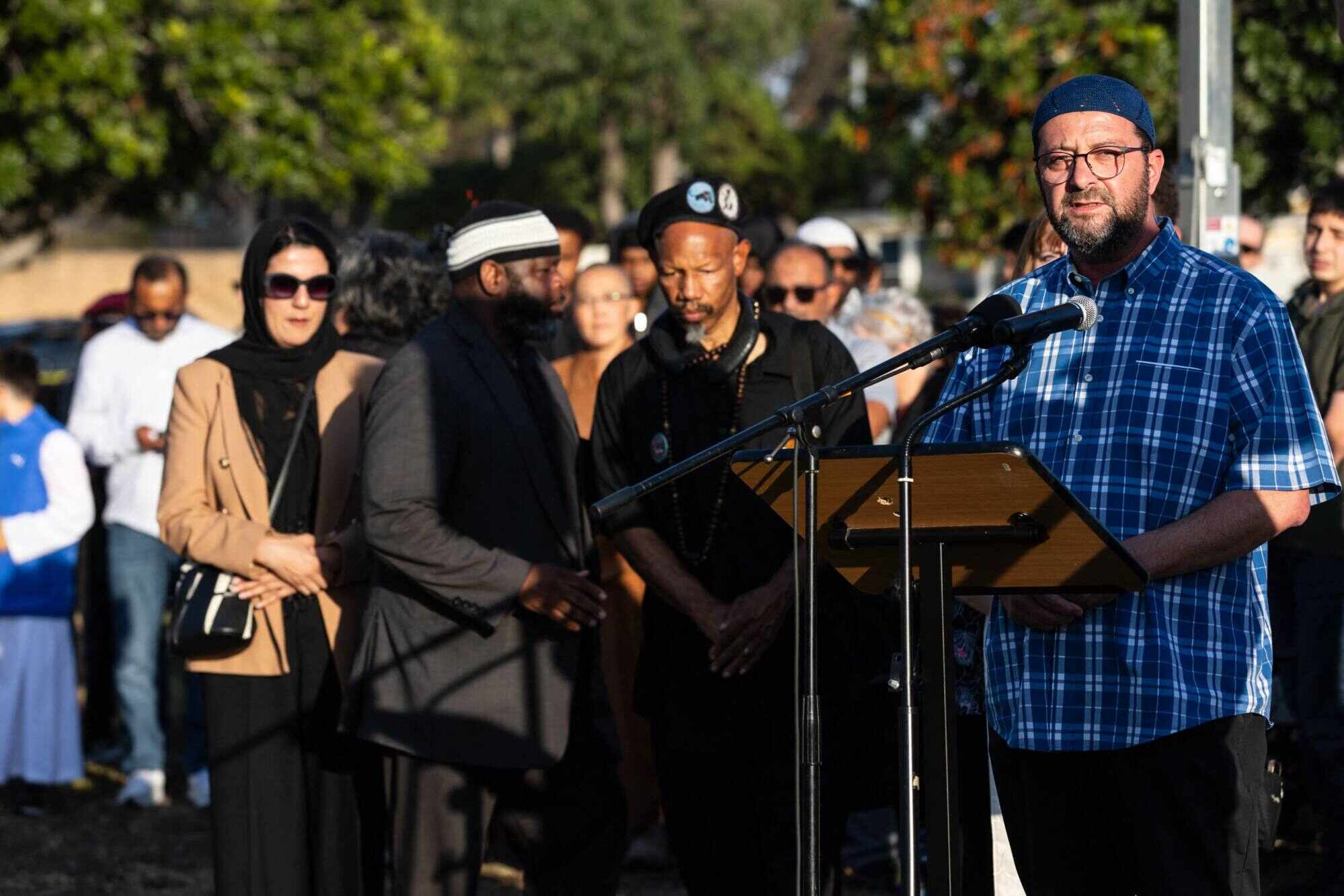 Imam Taha Hassane speaks at a vigil for victims and families. Photo: AFP