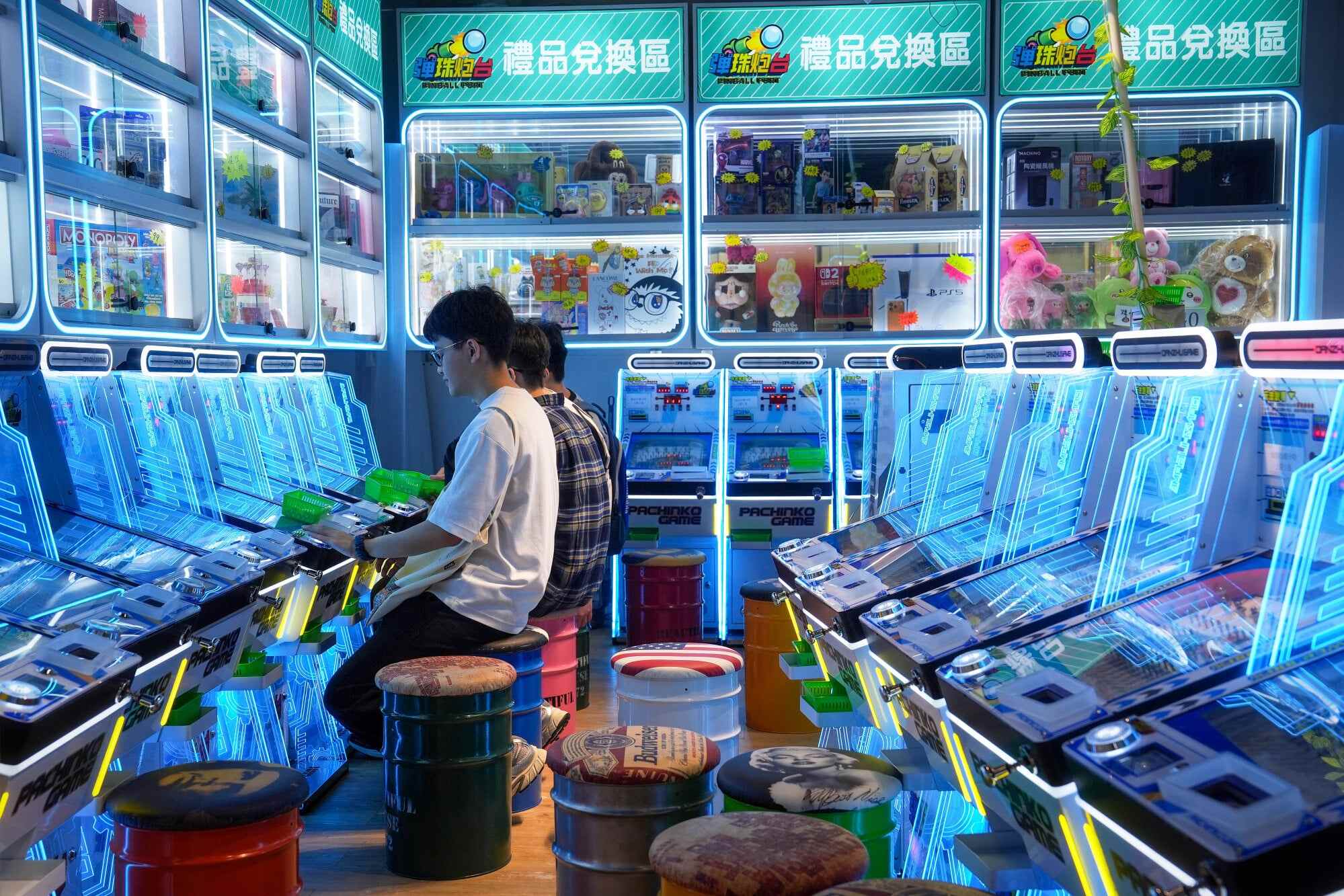 Young people play at a pinball machine shop in a shopping centre in Sham Shui Po. Hong Kong authorities have even considered amending gambling laws to tighten oversight of claw machines and prize-based games. Photo: Elson Li