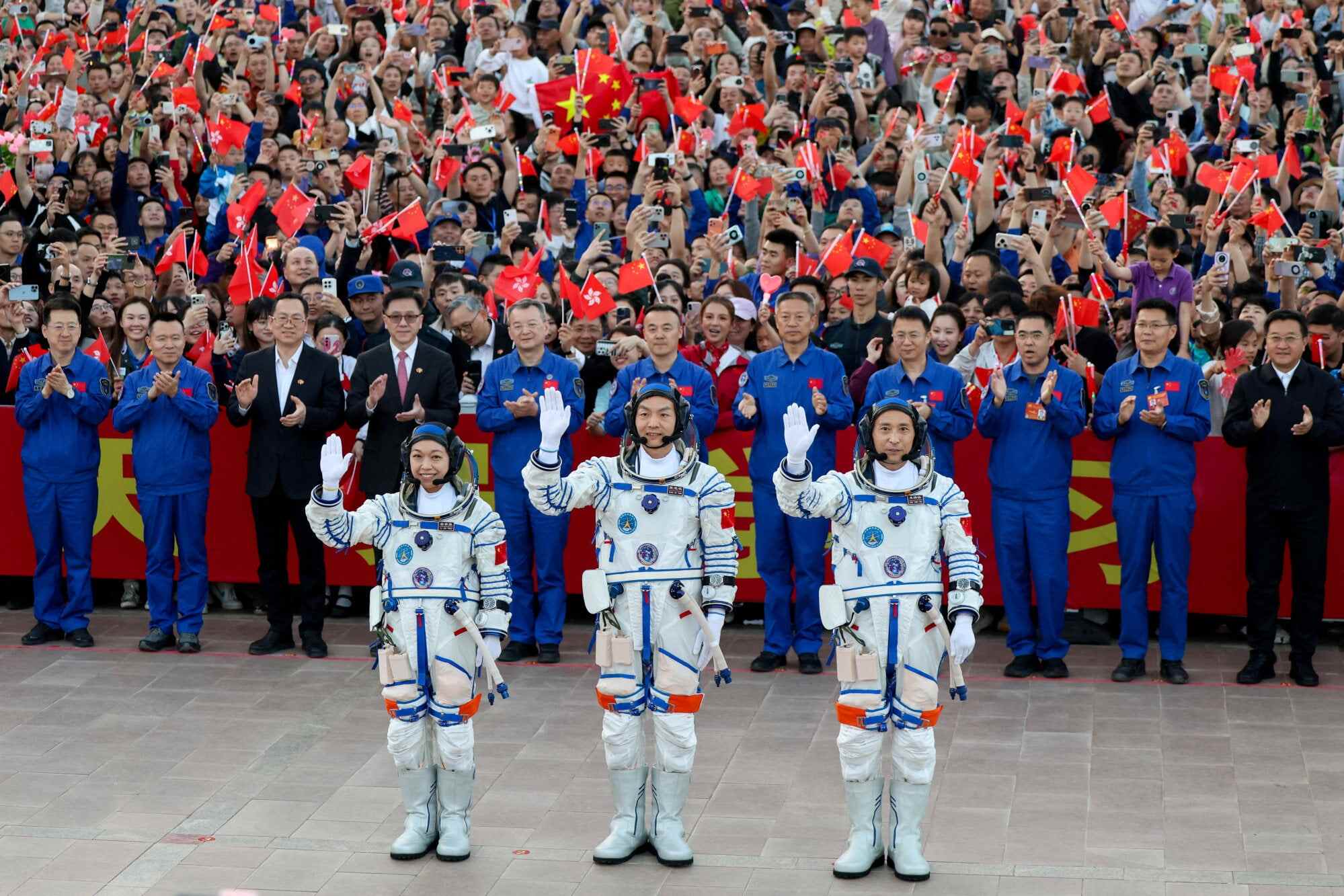 Astronauts Zhu Yangzhu, Zhang Zhiyuan and Lai Ka-ying wave during a see-off ceremony before taking part in the Shenzhou-23 space flight mission. Photo: Reuters