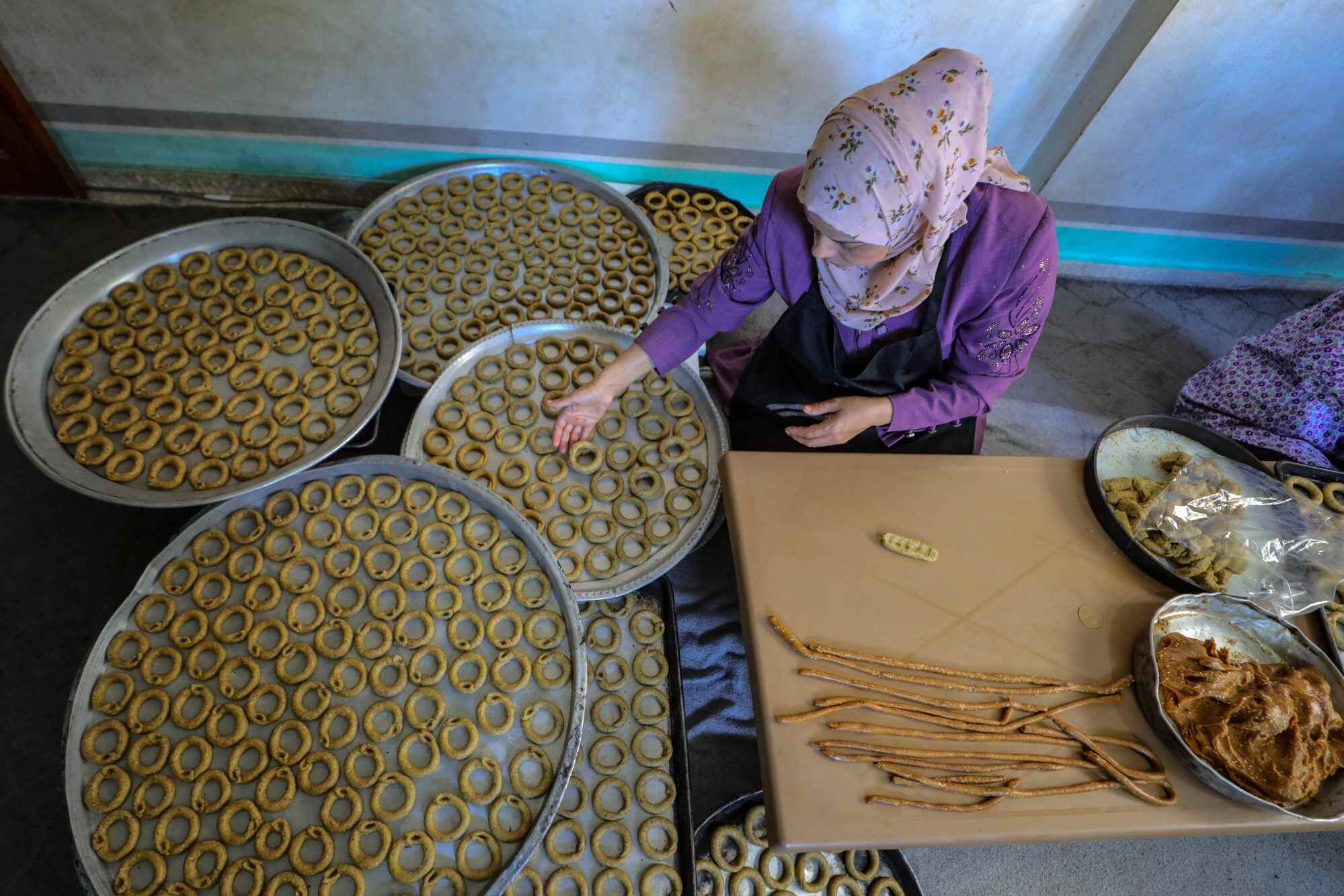 A Palestinian woman prepares traditional cookies in her home ahead of the Eid al-Adha festival in Gaza City. Photo: AFP