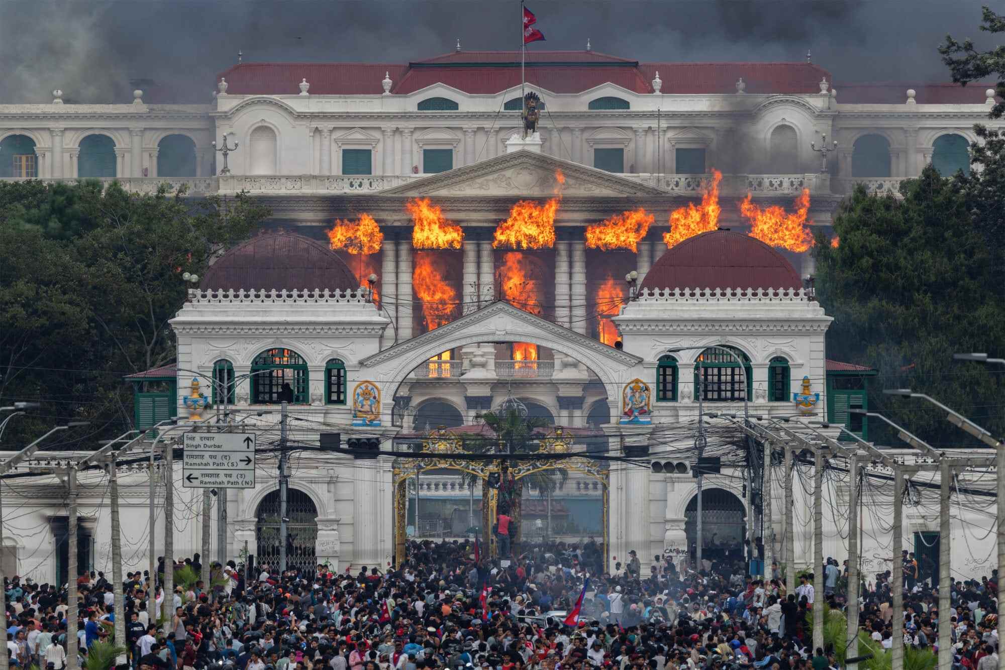 Fire and smoke engulf Singha Durbar after protesters stormed and set the government complex alight during demonstrations in Kathmandu, Nepal. Photo: EPA