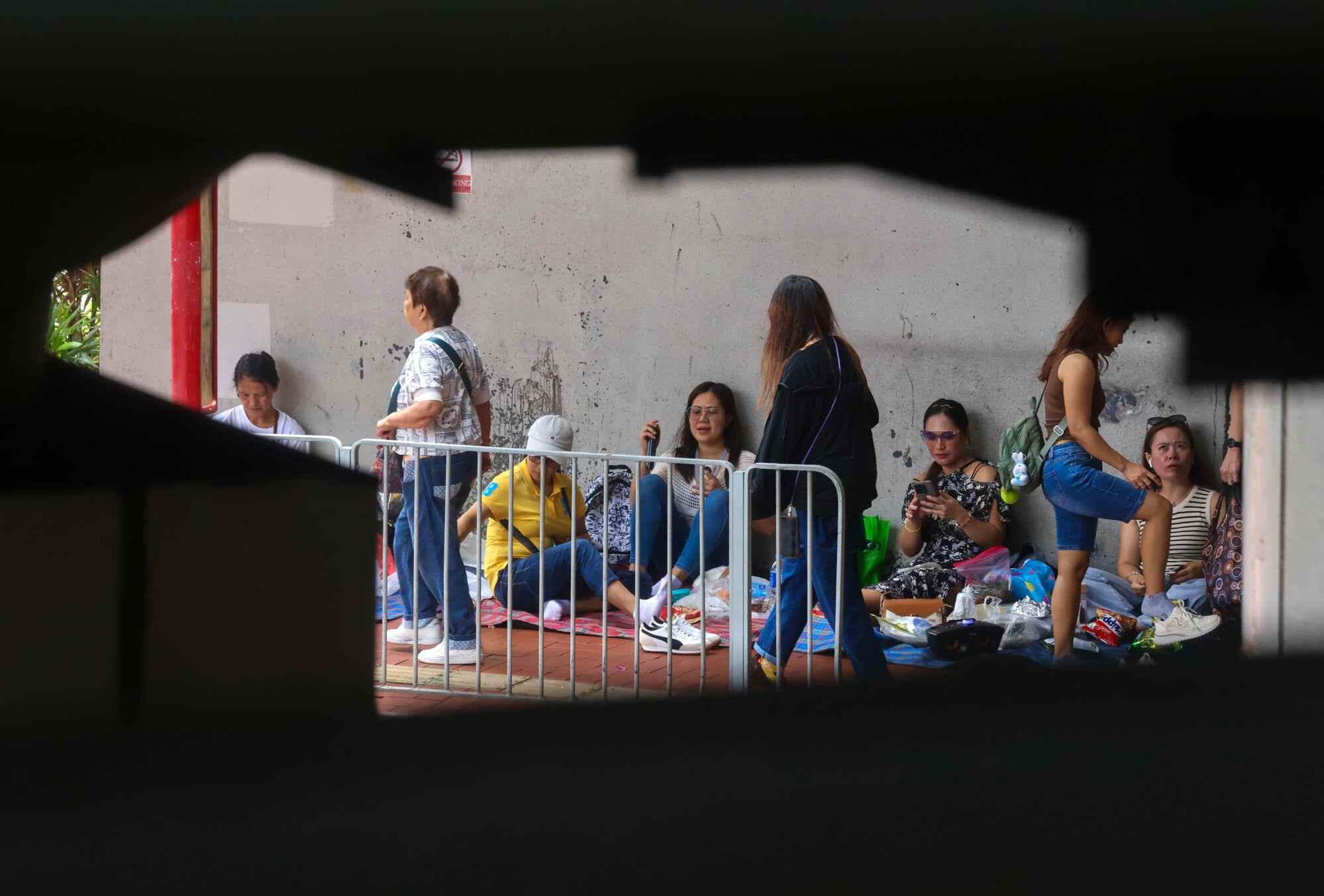 Domestic helpers in Tsuen Wan. The Hong Kong Observatory issued its third “very hot weather” warning signal this week on Tuesday morning and reminded residents to stay hydrated, even indoors. Photo: Jonathan Wong
