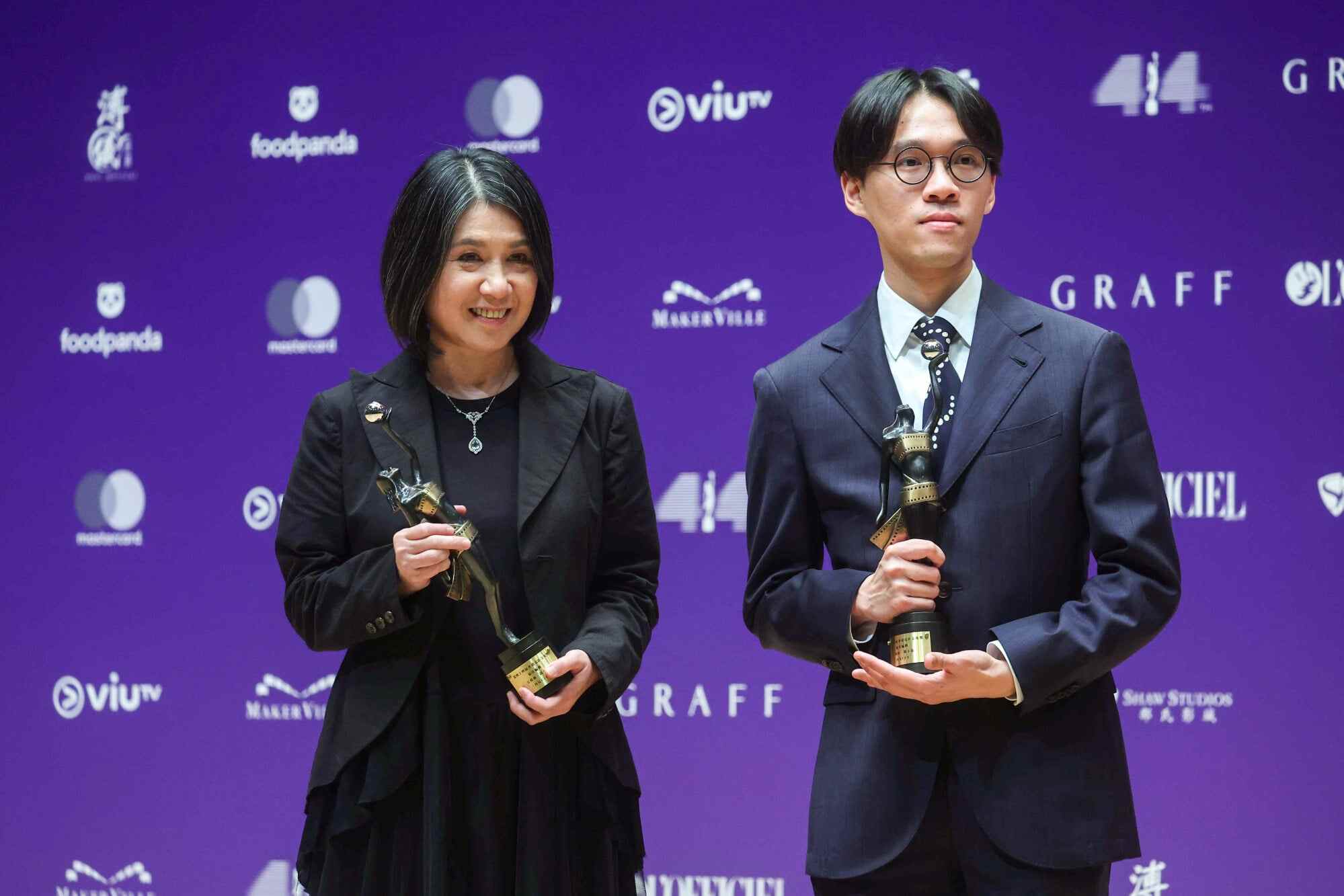 Amy Chin and Kong Ho-yan (right) hold up trophies for their best screenplay win at the 44th Hong Kong Film Awards. Photo: Edmond So