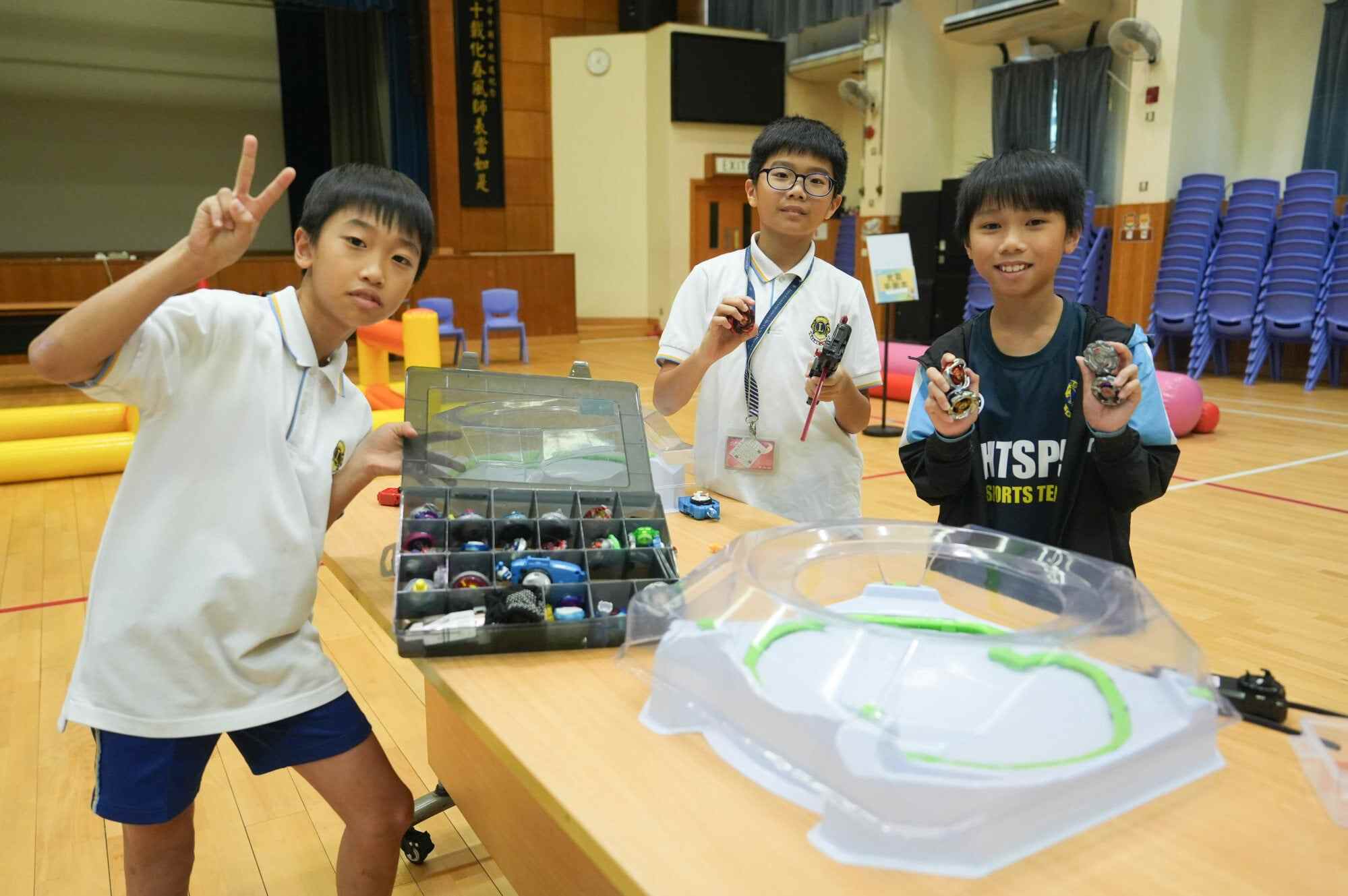 Daniel Keung Tsz-chung (left) – pictured here with a classmate and Cheung Chun-nok (right) – shows off his prized Beyblades collection. Photo: Sun Yeung