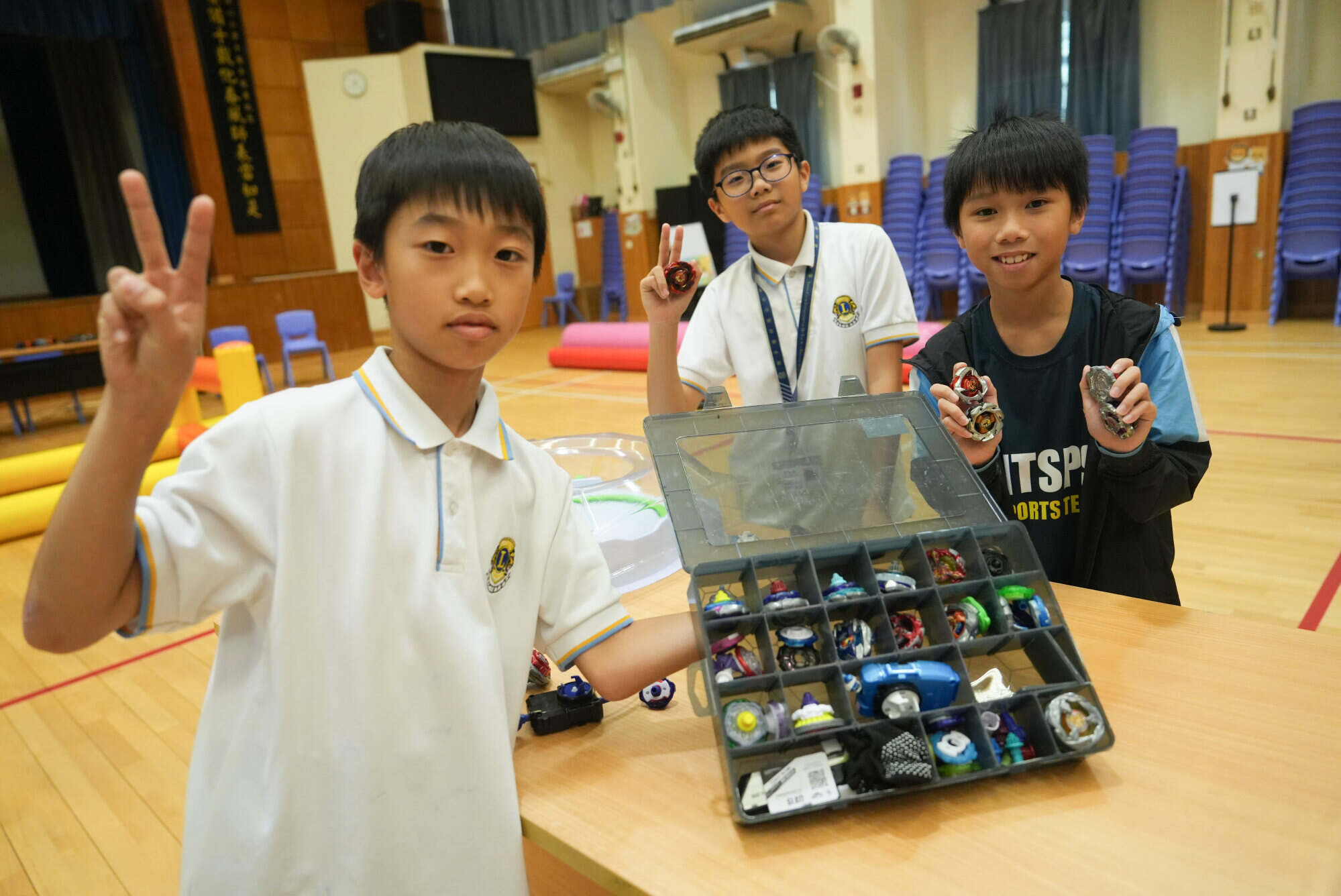 Daniel Keung Tsz-chung (left) – pictured here with a classmate and Cheung Chun-nok (right) – shows off his prized Beyblades collection. Photo: Sun Yeung