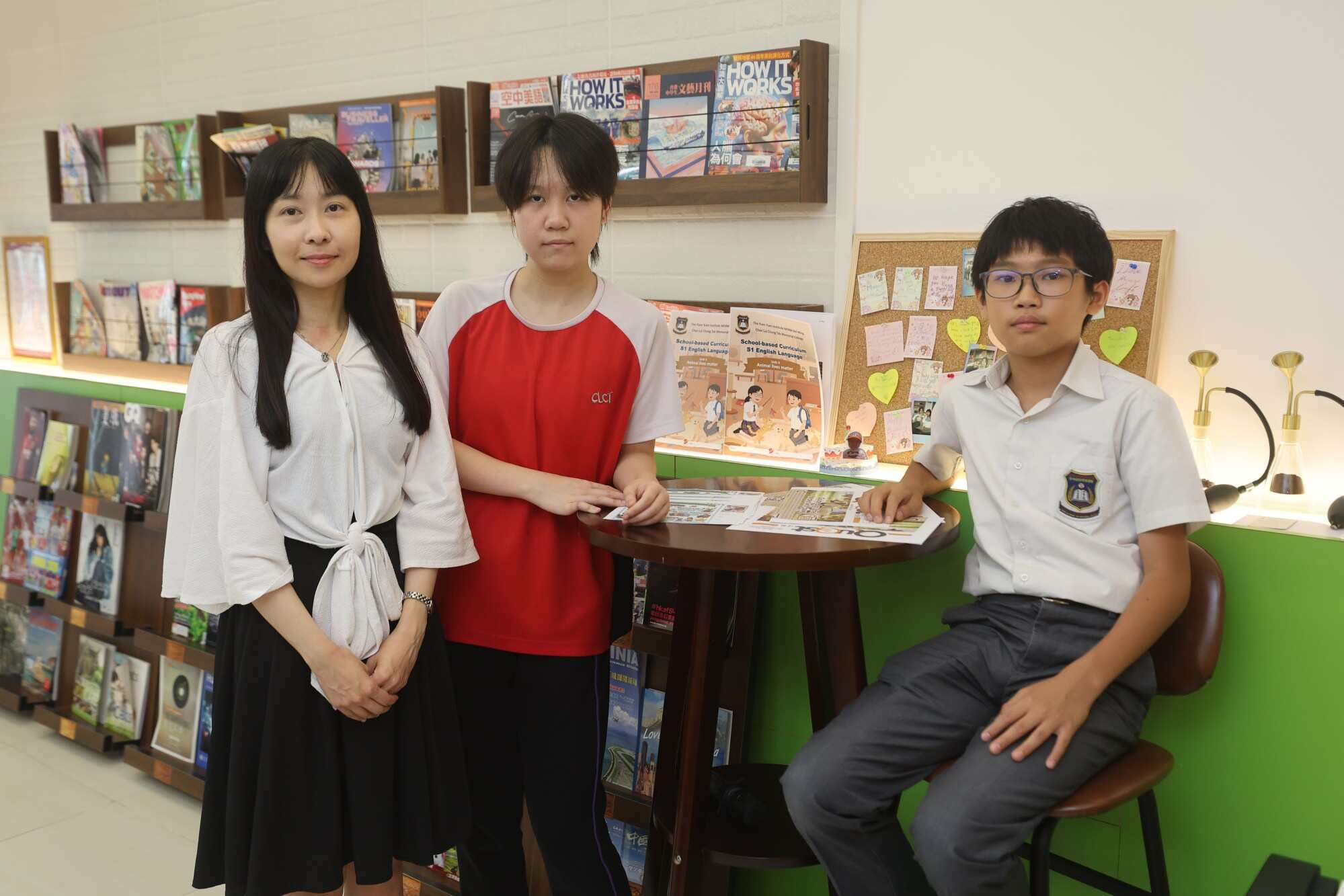 Through fun English reading materials, films and games, this cat cafe provides a comfortable environment for learning. Photo: Edmond So