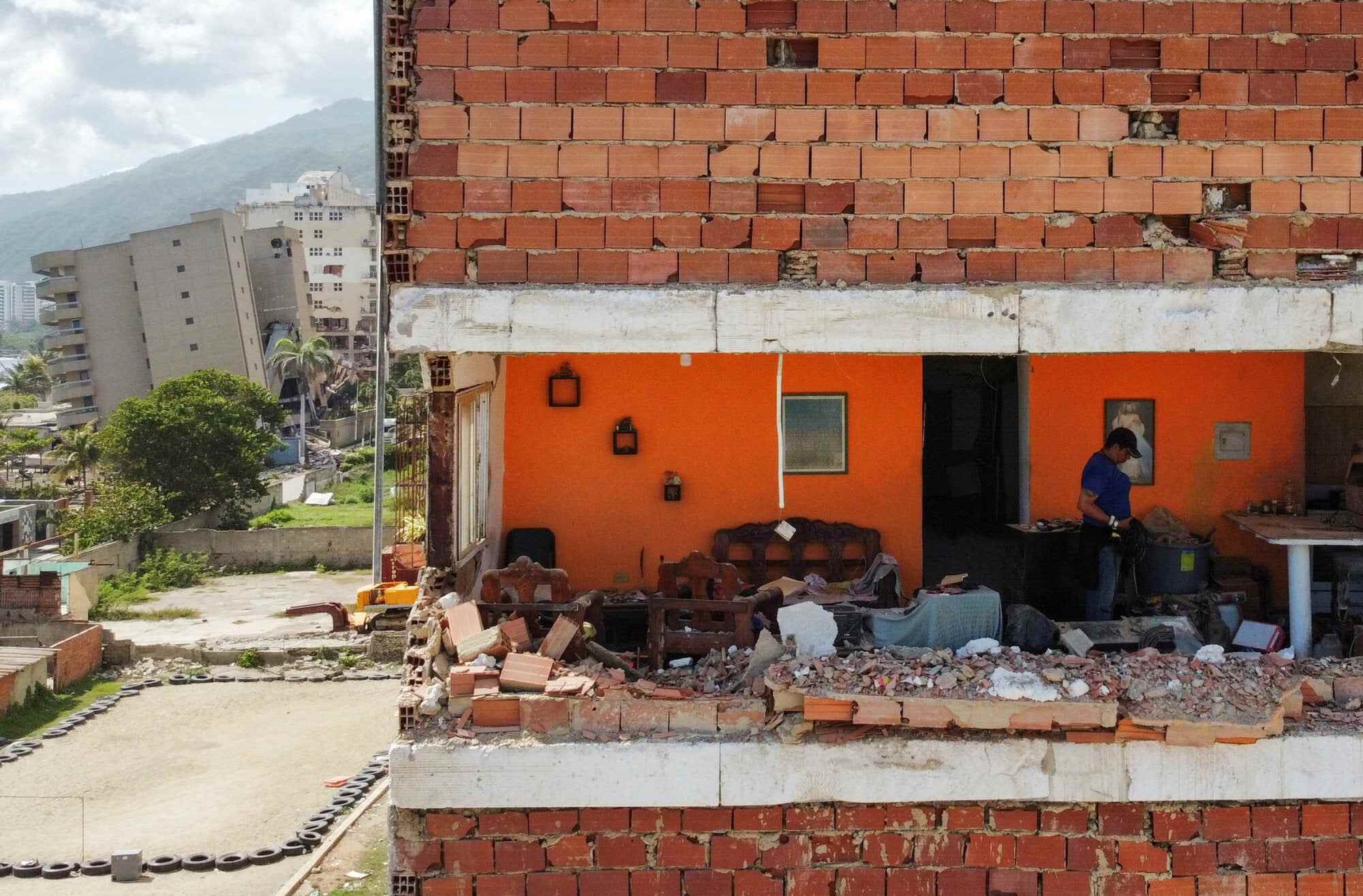 A drone view shows a person inside a home in La Guaira that was destroyed by Wednesday’s earthquakes. Photo: Reuters