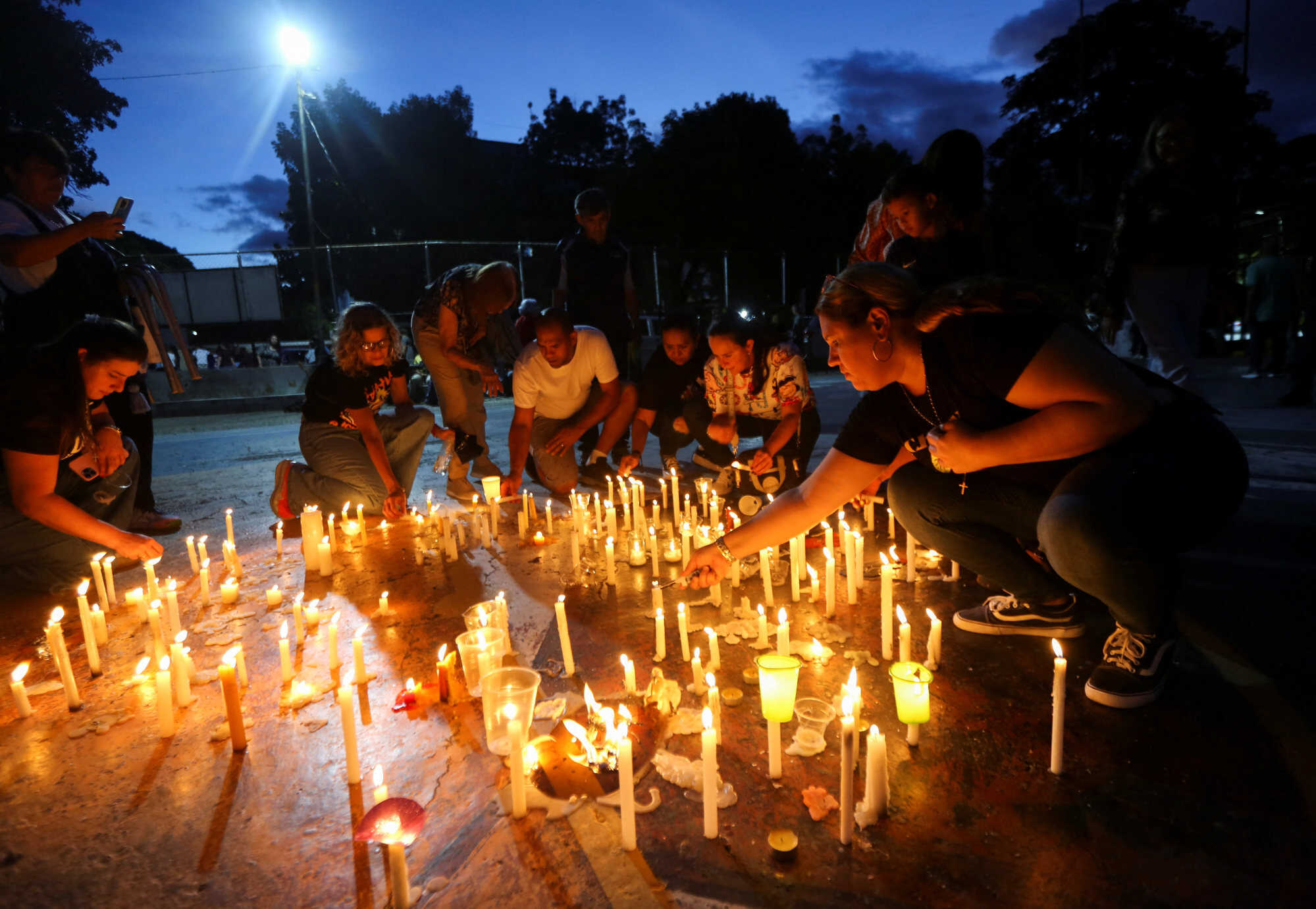 People light candles as they attend a vigil outside the Nuestra Señora de los Dolores church to pray for victims. Photo: Reuters