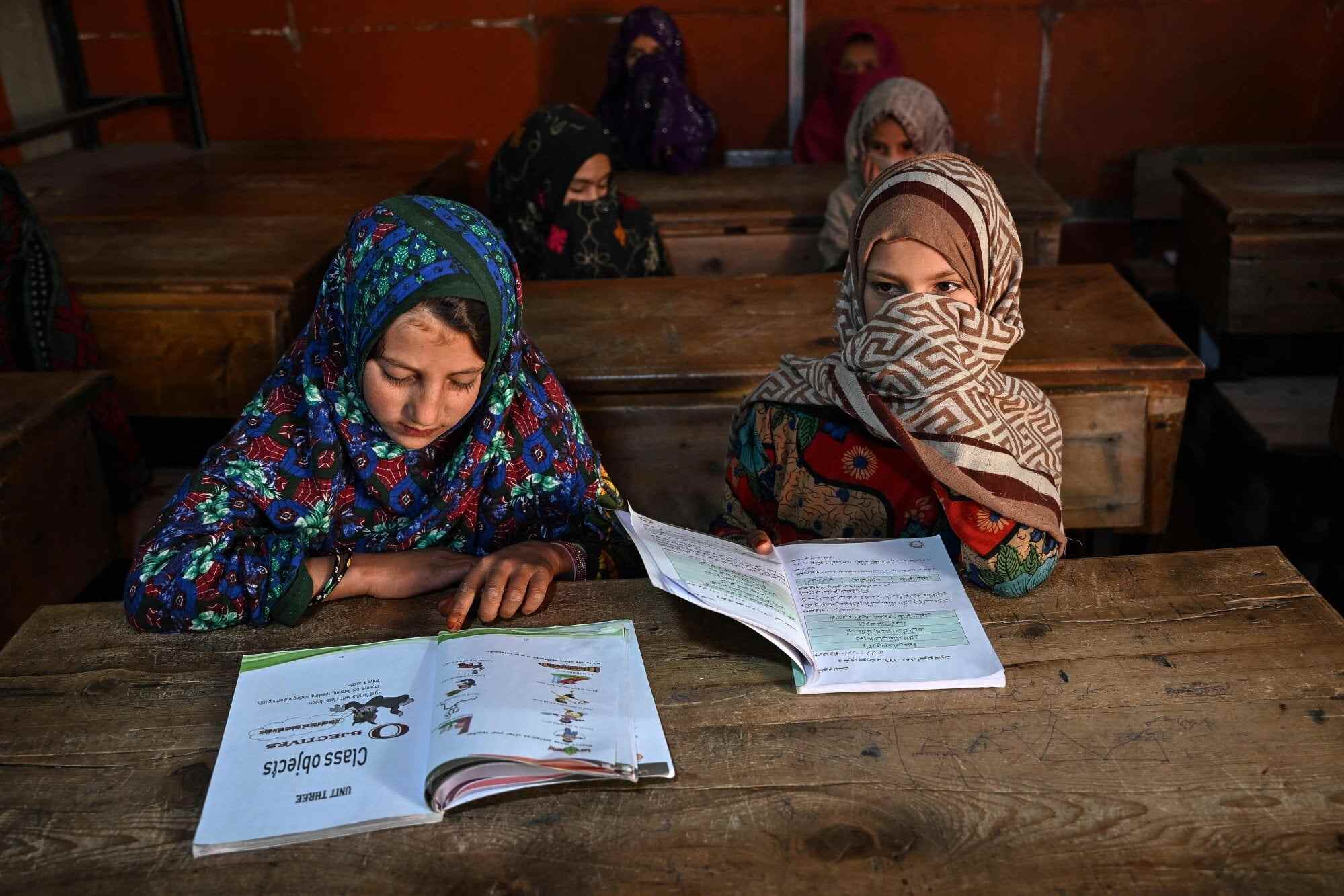 Habiba’s daughter Nahida (left) attends a class at a primary school in Eshtiwi. Nahida is 11, but her education will soon stop as the Taliban government has banned girls from education after the age of 12. Photo: AFP
