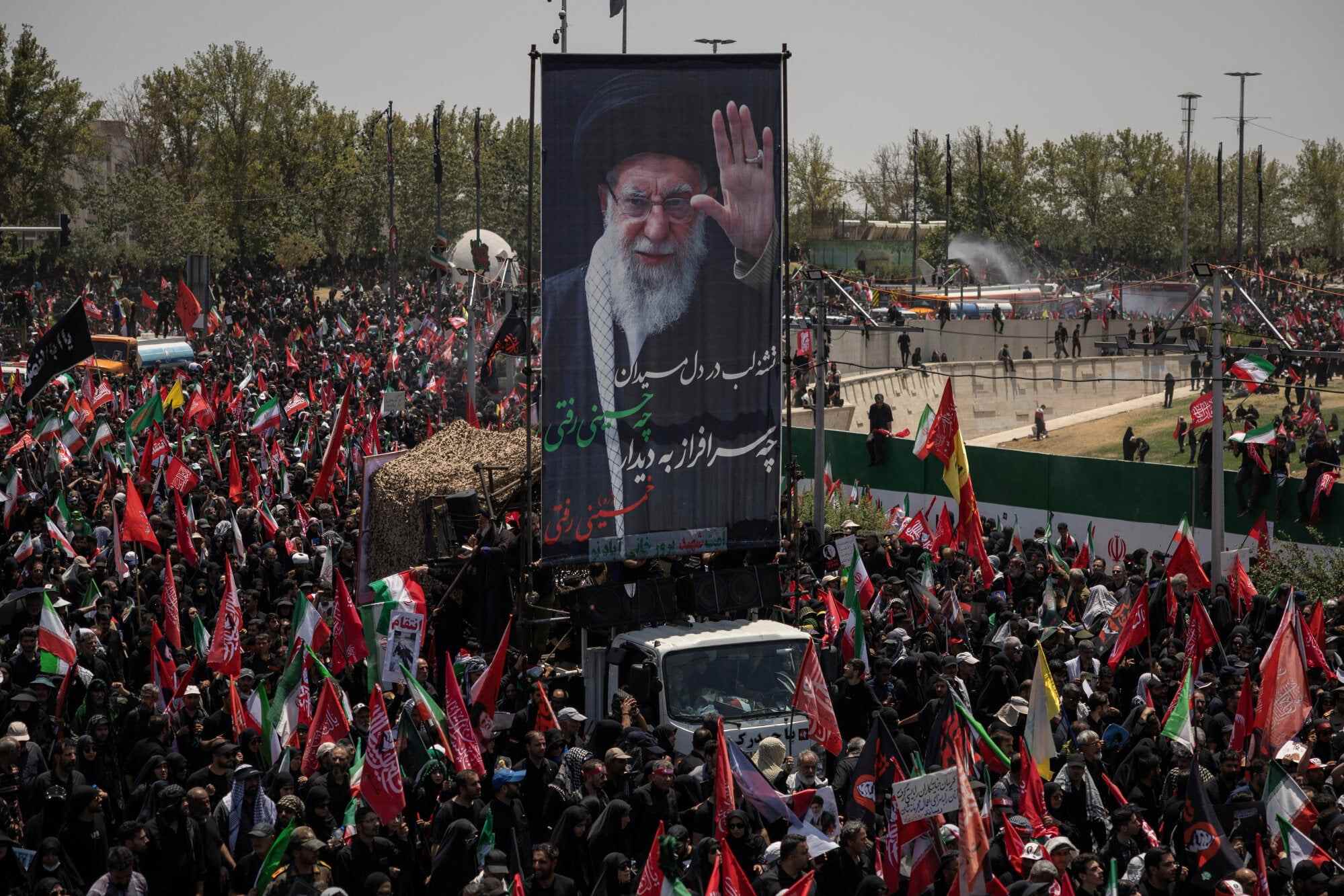 A vehicle carrying a banner depicting Iran’s late Supreme Leader Ayatollah Ali Khamenei, who was killed on February 28 in Israeli and US air strikes, makes its way as people attend his funeral procession in Tehran, Iran. Photo: Reuters