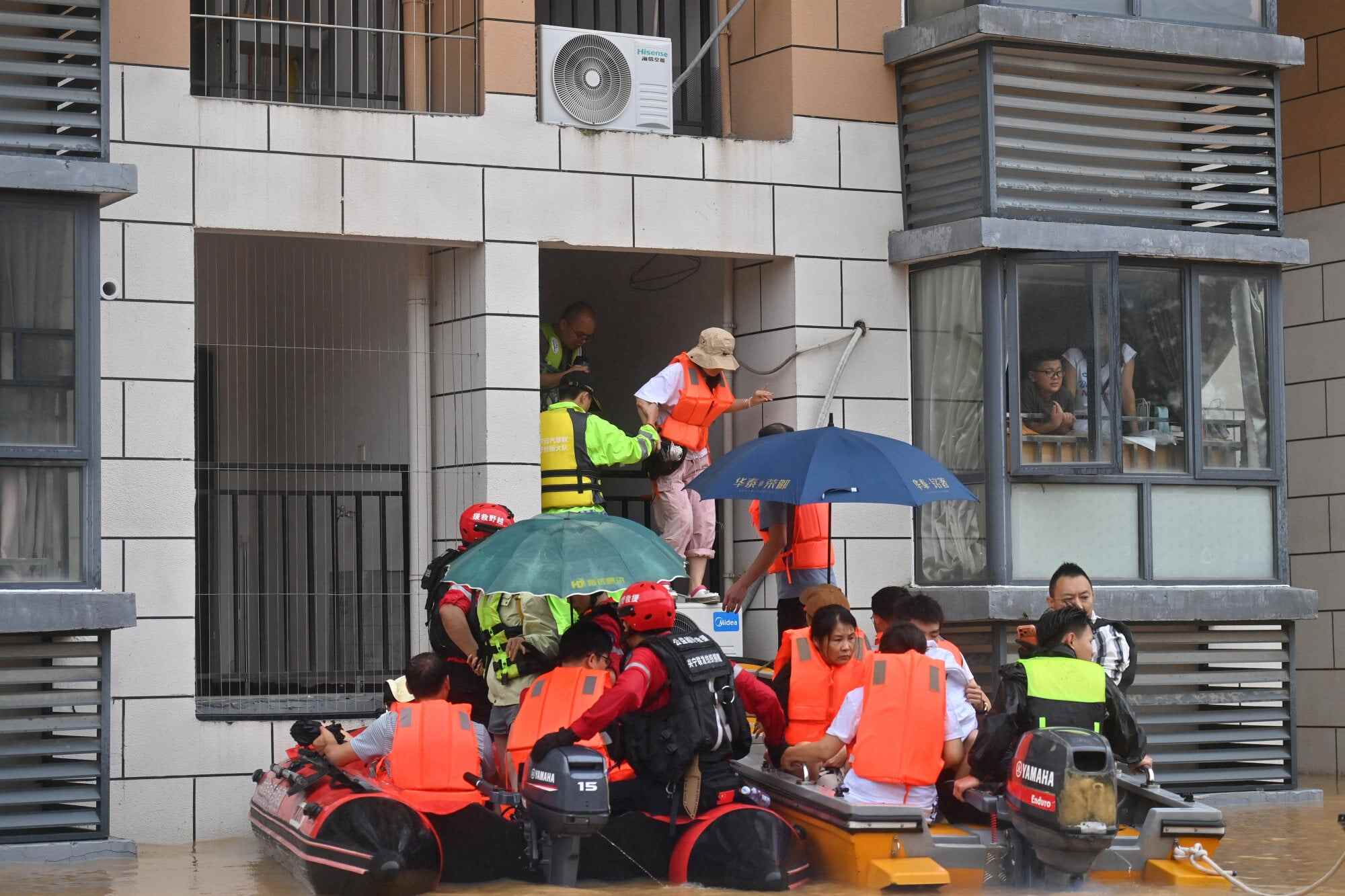 Rescuers evacuate stranded teachers and students at Xijiang Education Park in Guigang. Photo: Xinhua