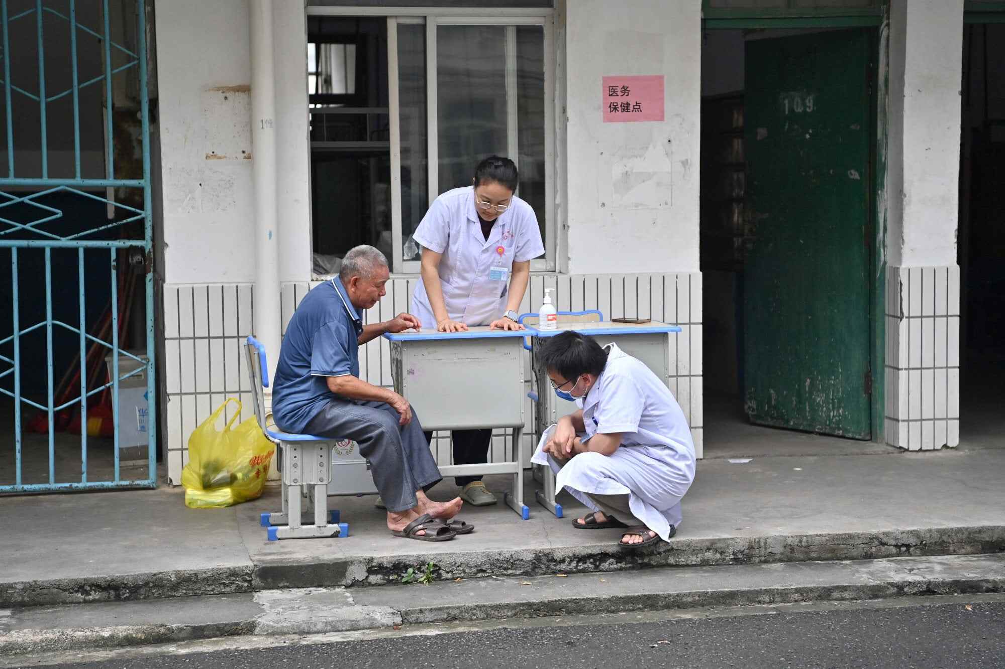A flood-affected resident receives medical attention at a temporary relocation site in Guigang city, in Guangxi. Guigang has set up 18 temporary relocation sites to shelter flood-affected residents. Photo: Xinhua
