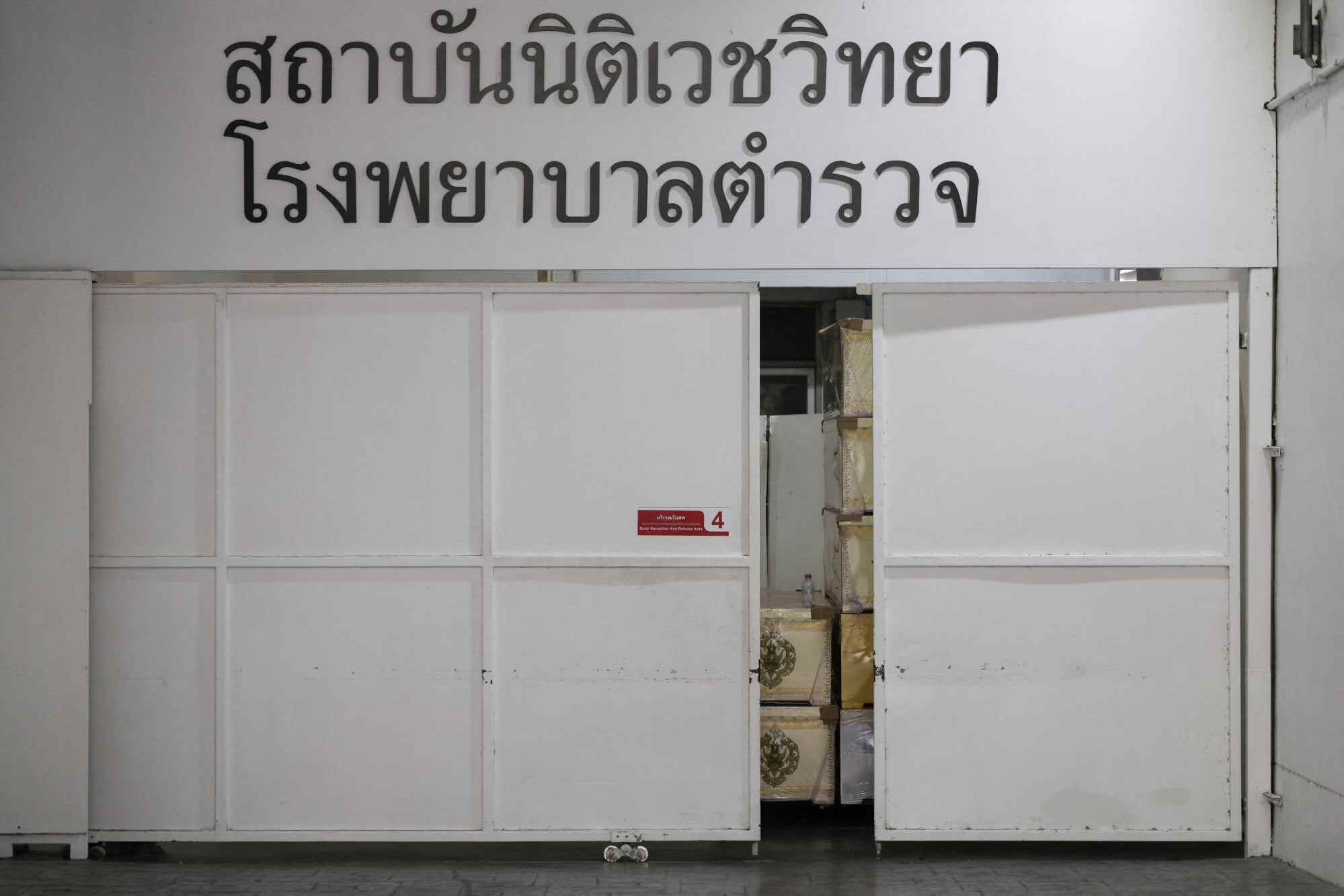 Coffins sit behind a door at the police hospital morgue. Photo: Reuters
