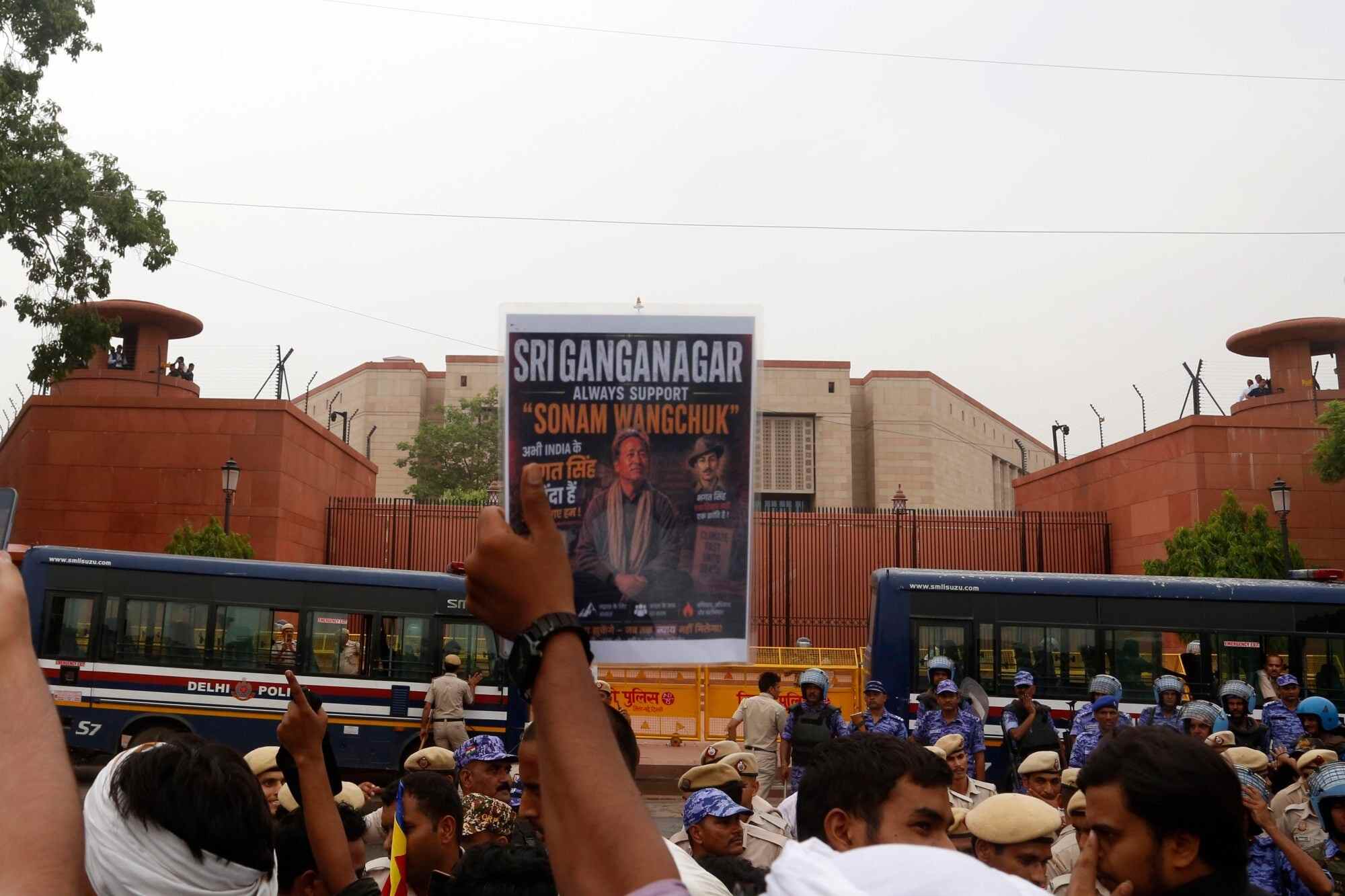 A supporter of the Cockroach Janta Party holds up a poster showing hunger-striking activist Sonam Wangchuk during a protest outside India’s Parliament building. Photo: AP