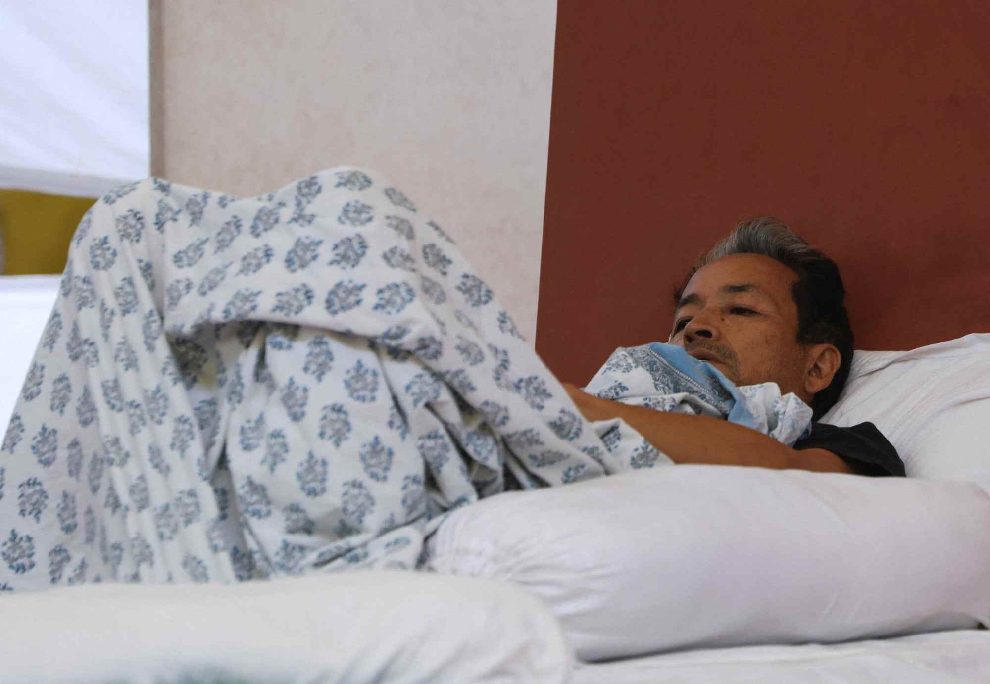 Sonam Wangchuk, an Indian education reformer who has been on hunger strike, rests on stage before being taken to the hospital by the authorities on July 18. Photo: Reuters