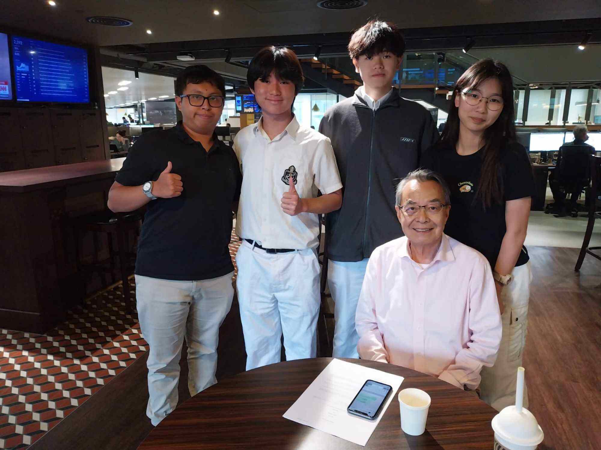 Jack Ching (from left), Nathaniel Sung and Anson Ho are students who have benefited from the group founded by Philip Leung (bottom right). Photo: Cherish Chiu